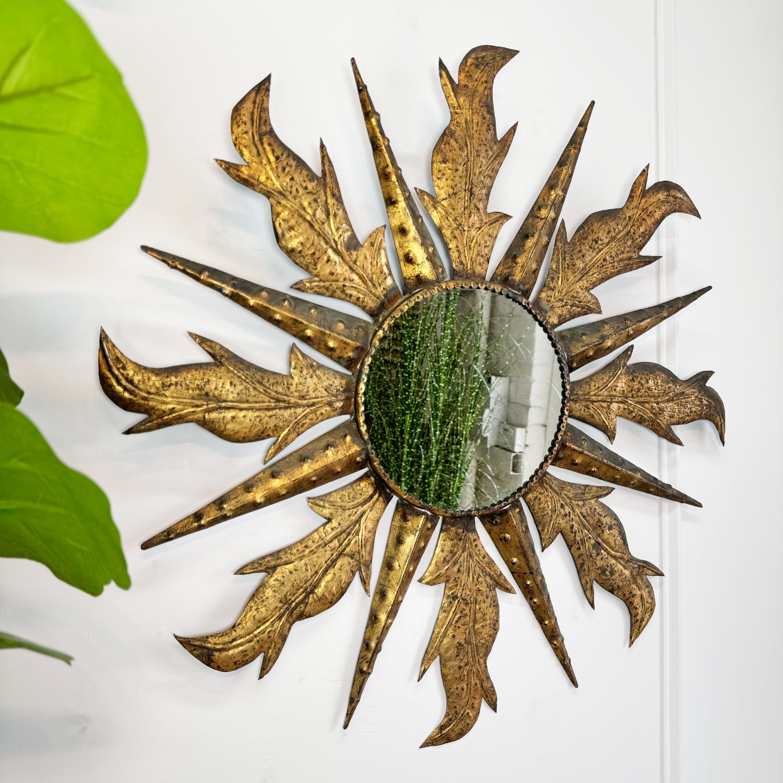 A fabulous example of an iron gilt Spanish sunburst mirror, circa 1950's. The golden sunburst rays, each individually crafted and of unusual deign and superbly detail emanate from the central circular mirror plate.

 
The original mirror plate