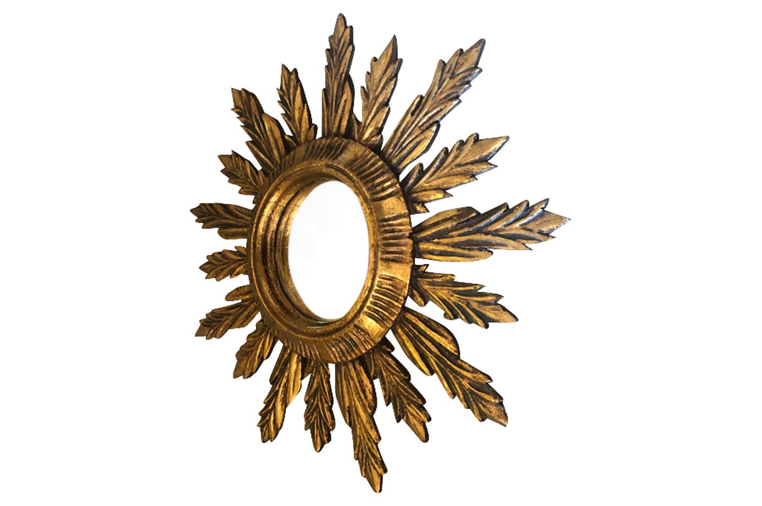 A wonderful sunburst mirror from the Catalan region of Spain. Hand carved from giltwood. A wonderful accent piece.