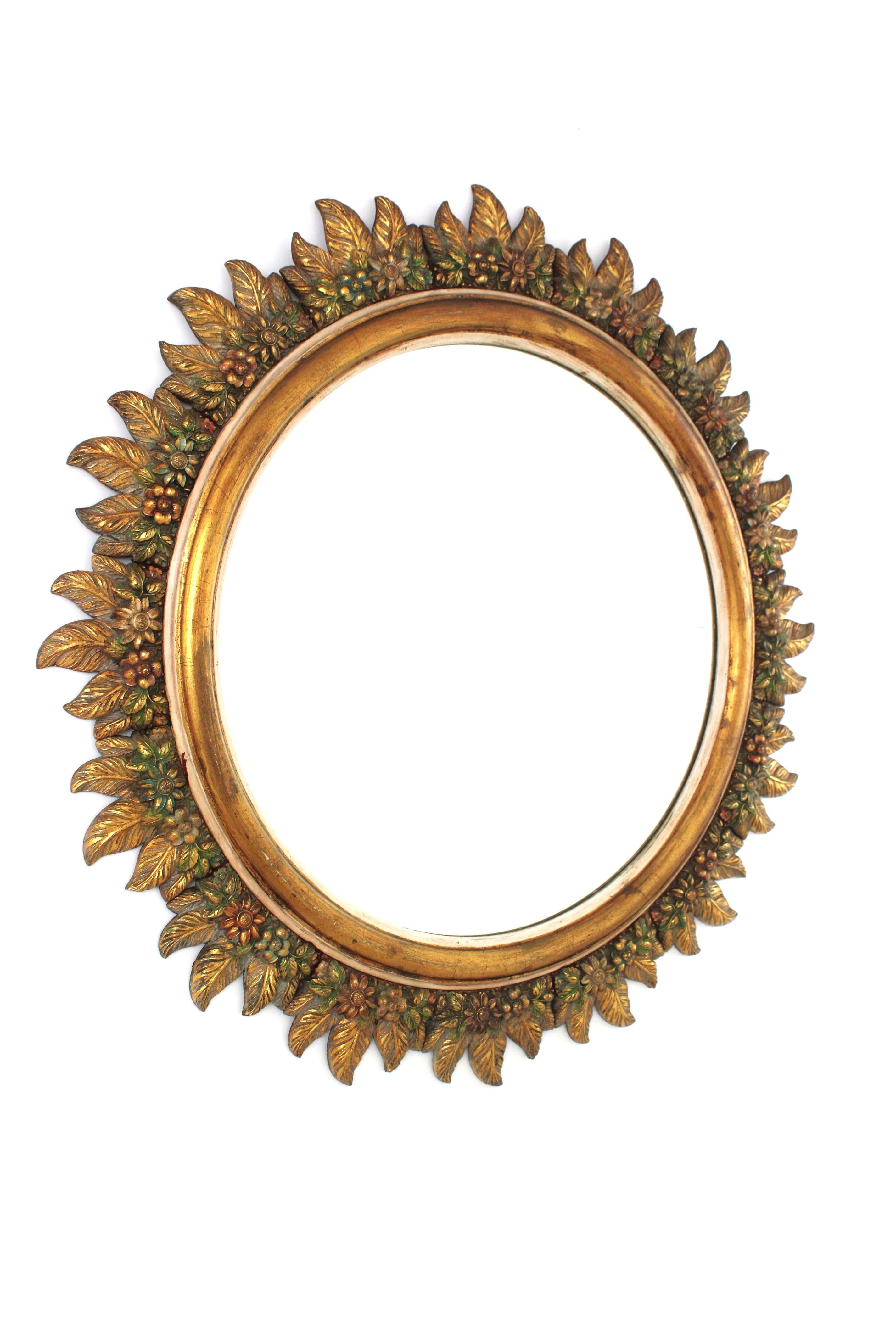 Mid-Century moderno Spanish Sunburst Mirror in Giltwood with Flowers Carved Frame, 1950s in vendita