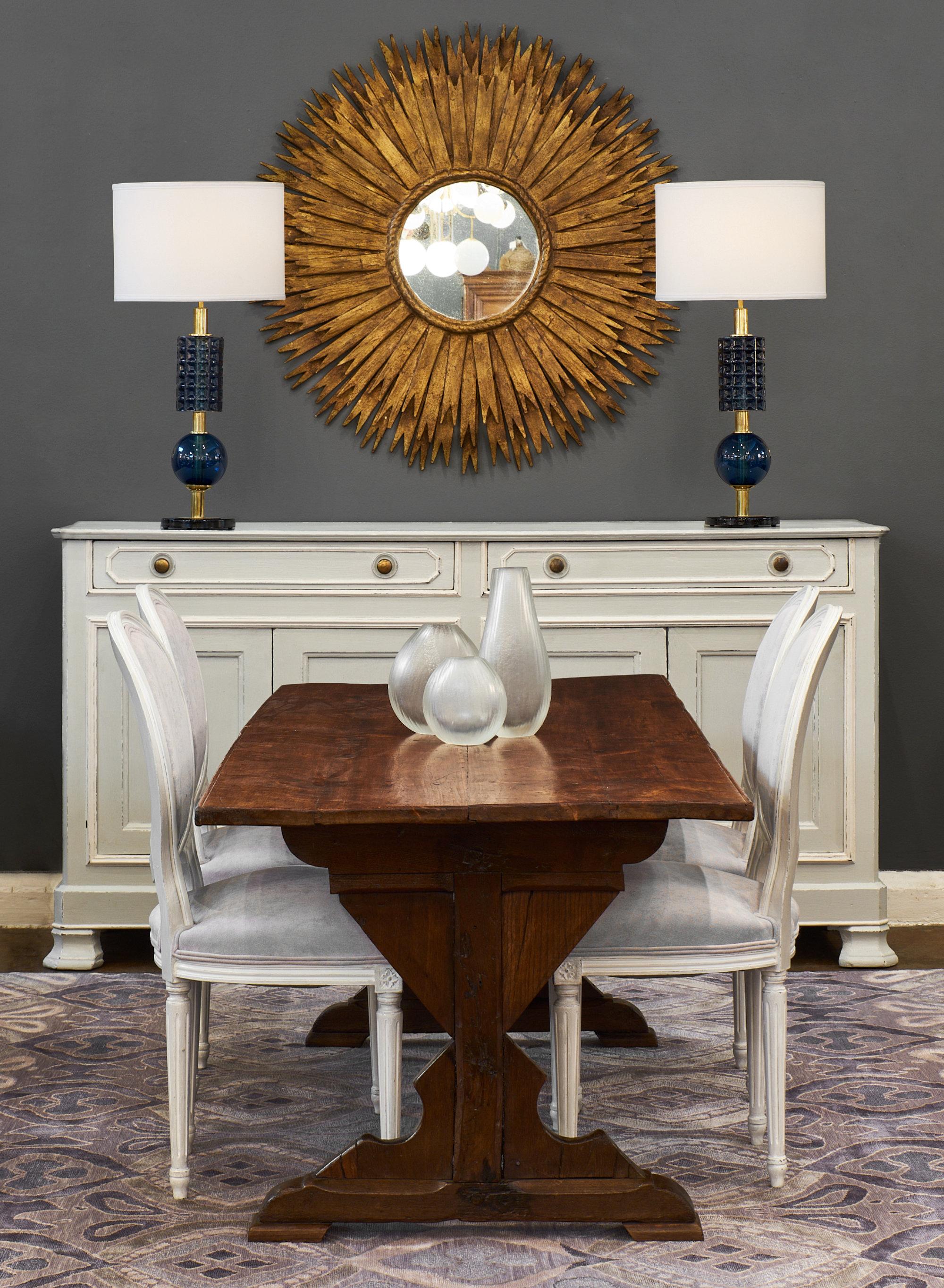 Pair of Spanish sunburst mirrors made of gold-leafed wood. We love the large size and classic aesthetic of this pair.