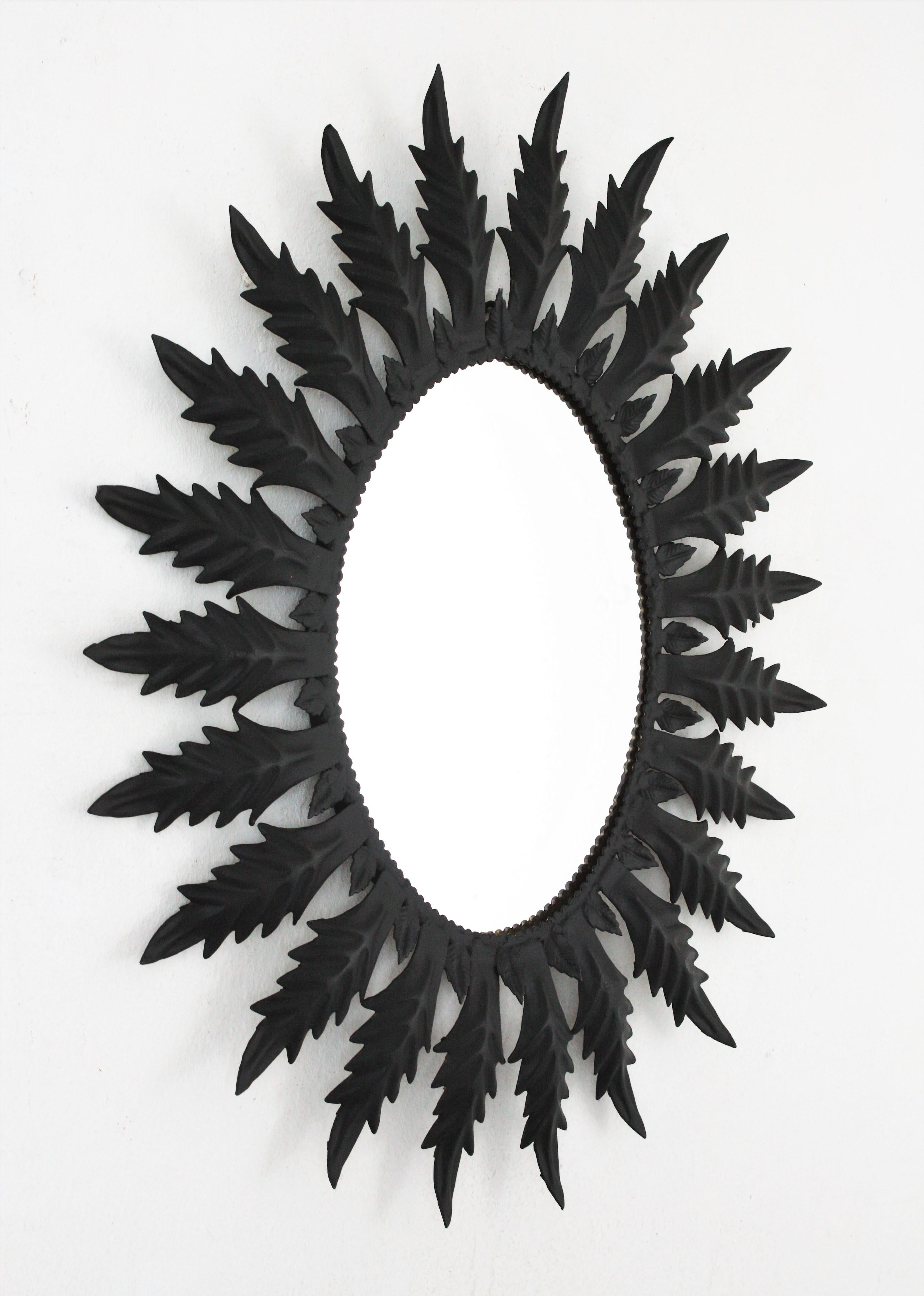 Mid-Century Modern Spanish Sunburst Oval Mirror in Black Painted Iron, 1960s For Sale