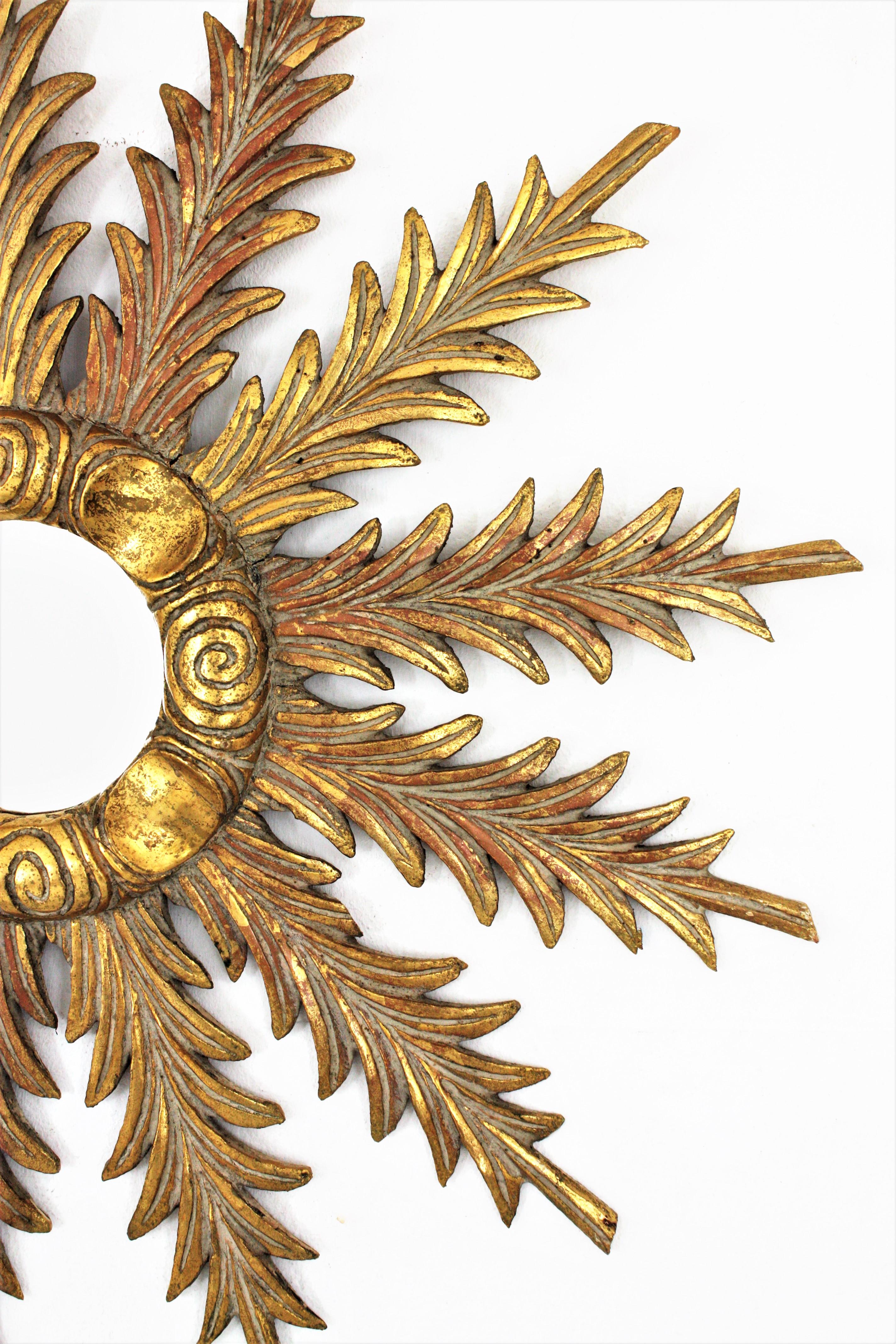 Spanish Sunburst Starburst Giltwood Mirror with Foliage Carvings, 1940s For Sale