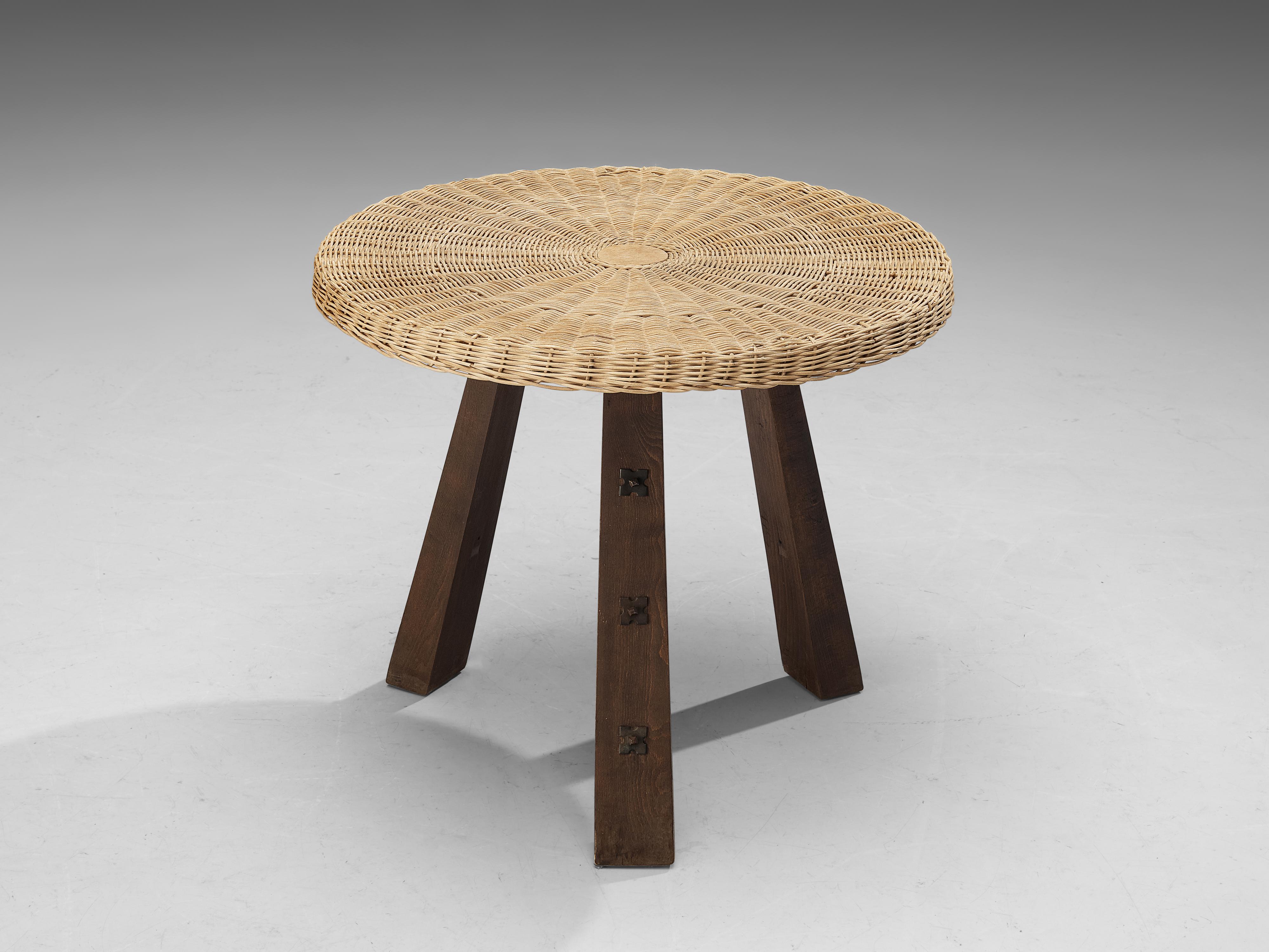 Table, cane wicker, beech, metal, Spain, 1950s

This table holds an intriguing wooden construction aptly defined by sturdy formalism. The legs are decorated in a refined manner consisting of metal studs, emphasizing the typical Mid-Century Spanish
