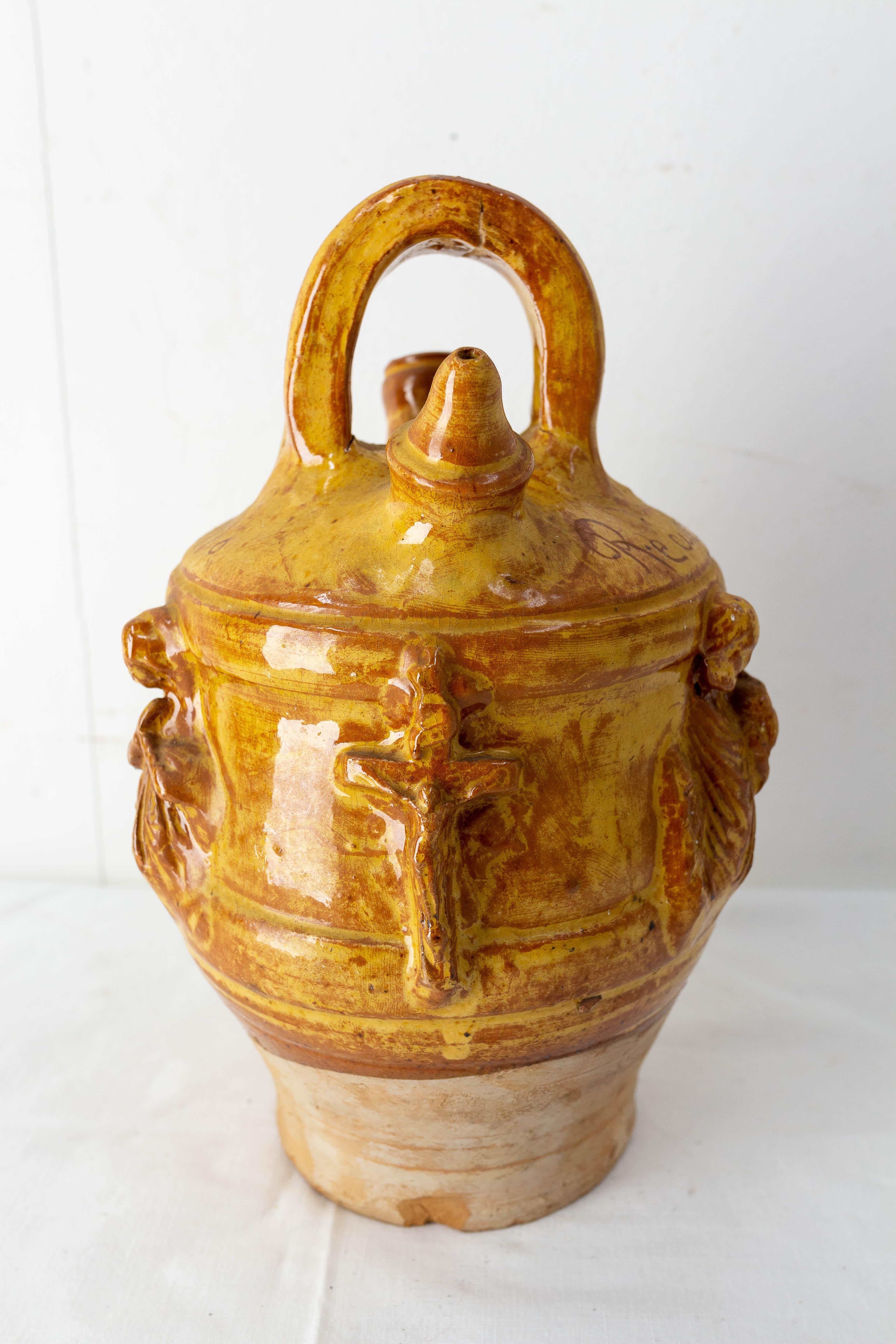 Terracotta jug with yellow glaze. This kind of pitcher is used to keep the water fresh. 
Made circa 1950, in a traditionnal style, in Astudillo, Spain, with the sentence 