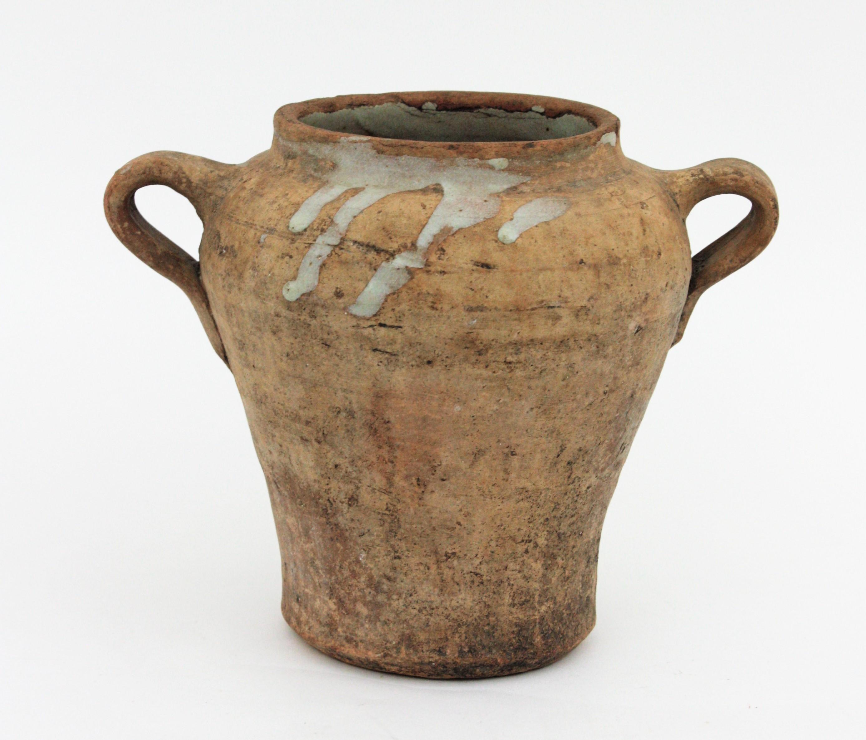 Handmade terracotta preserving pot or jar with handles from Segovia, Spain, 19th century.
Traditional Spanish ceramic 'orza'. Unglazed exterior with handles at both sides and cream color glaze at the interior to preserve olive oil and food.