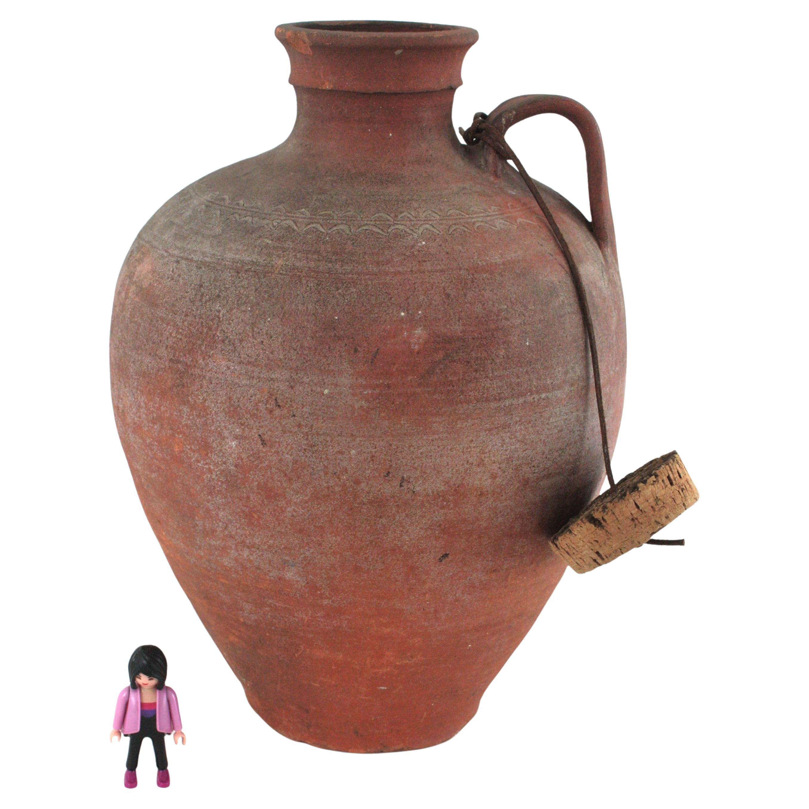 Spanish Handcrafted Rustic Water Jar with Plug, Terracotta
Hand-made terracotta single handled water jar with cork lid, Spain 1930s-1940s.
Traditional Spanish large terracotta jar or pitcher. Unglazed exterior and interior. Originally sed as water