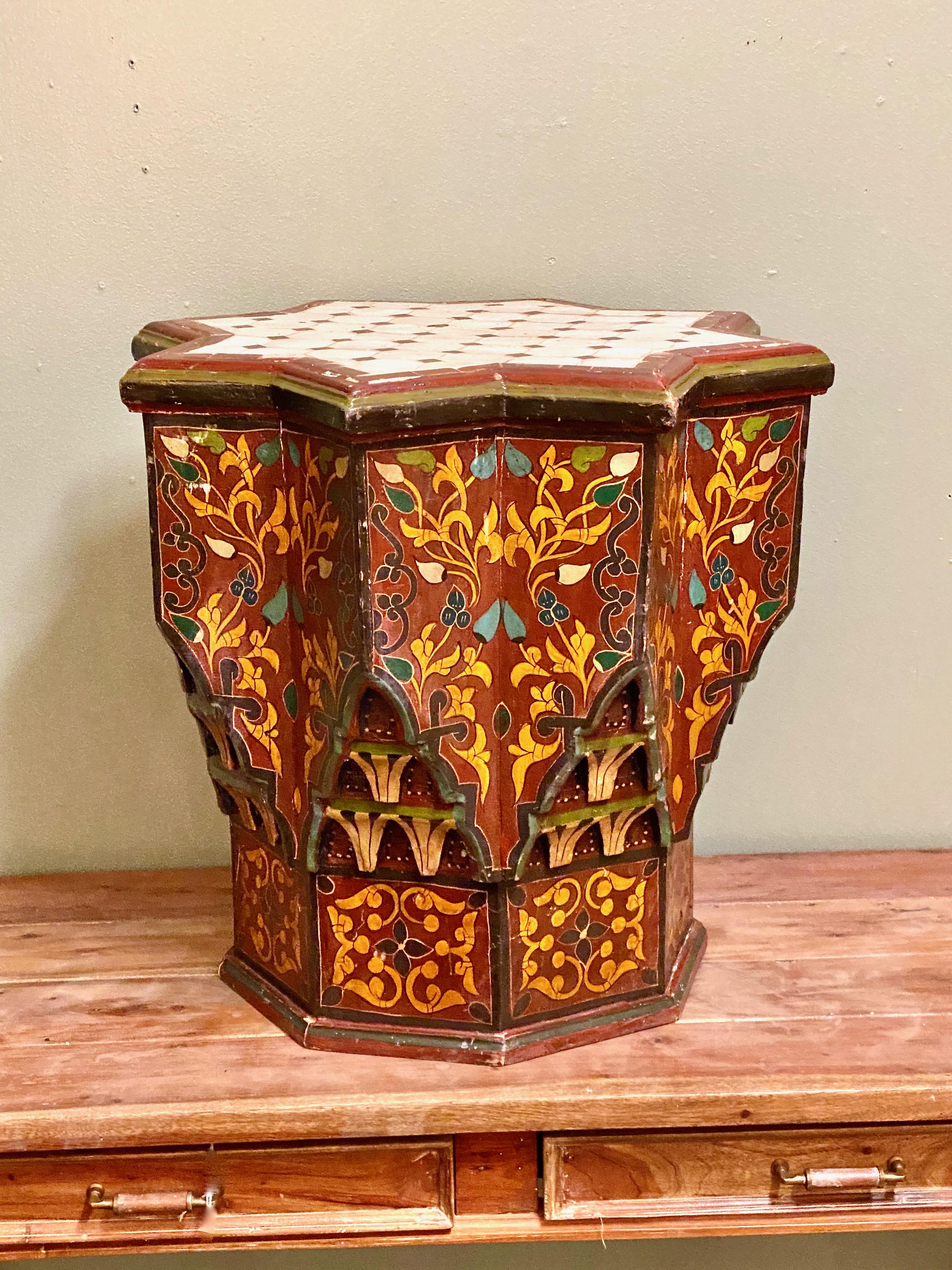 This is a very decorative Spanish star-form tile top occasional or drinks table. The table dates to the mid-20th century and is most probably from Sevilla, as indicated by its star-form structure and wonderfully painted base. This table would add a