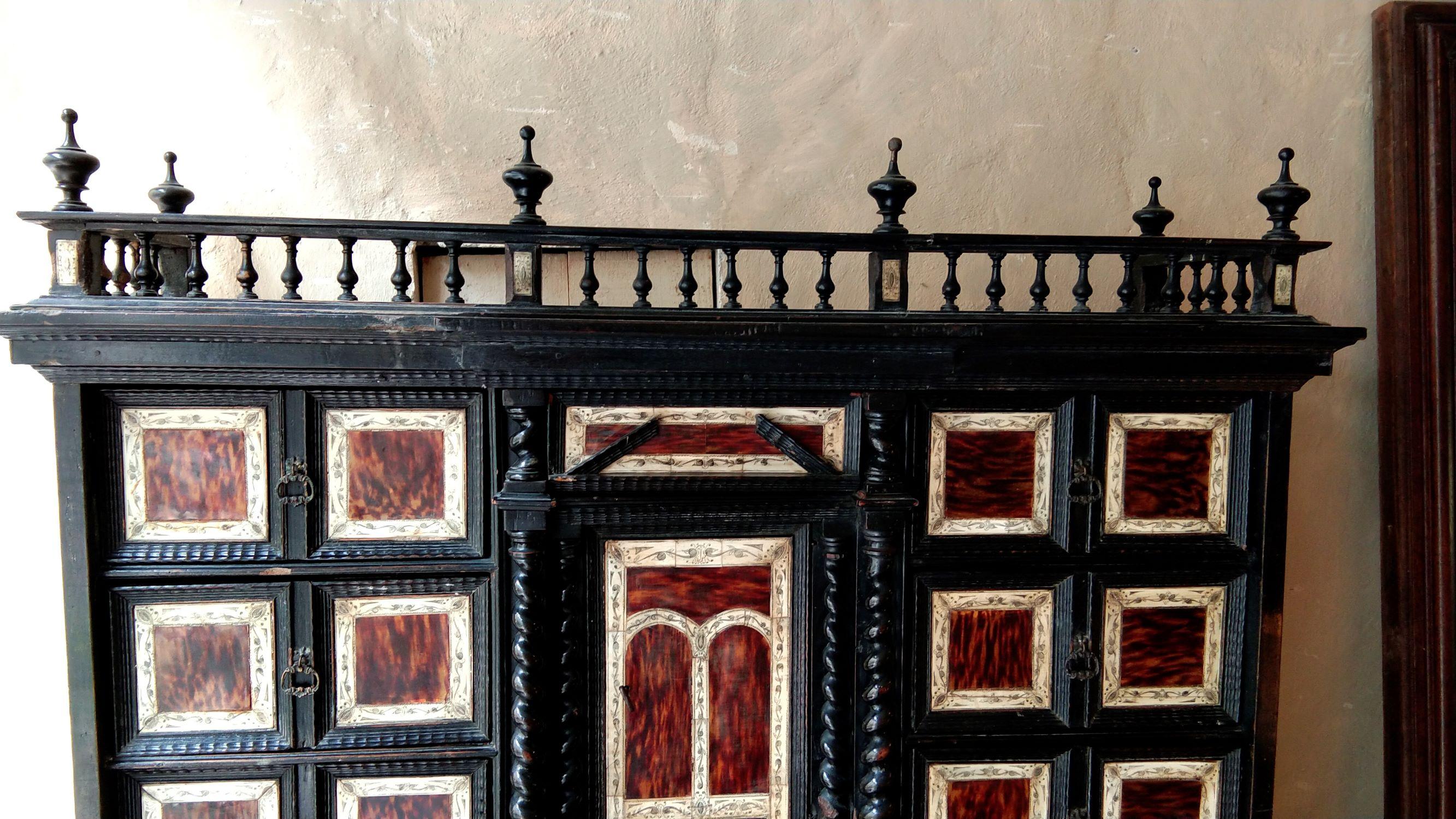 Ebony, pine, bone and tortoiseshell Renaissance Spanish cabinet from the 17th century. 
Cabinet of a rectangular form , on spherical feet with profiled, ebonised base. A center door, bordered by columns, reveals one interior secret drawer. 
Above