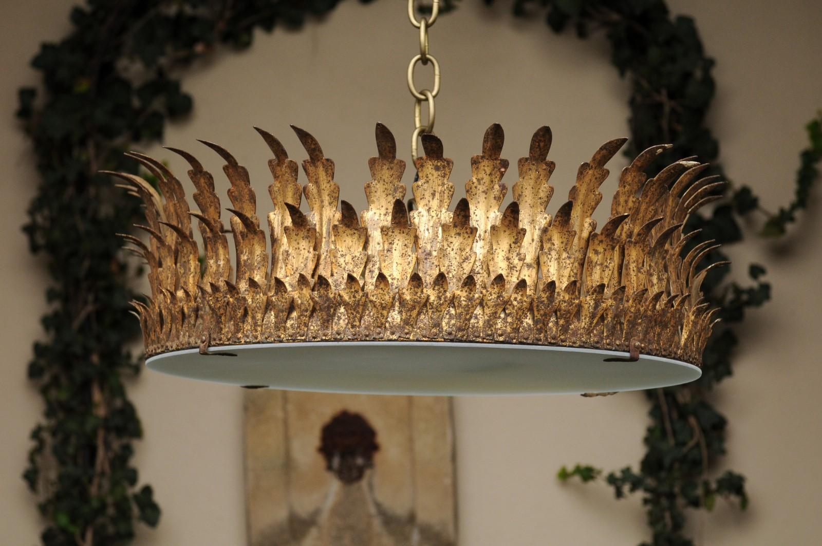 A Spanish vintage gilt metal three-bulb semi-flush crown light fixture from the mid-20th century, with frosted glass and new wiring. Born during the second quarter of the 20th century, this Spanish crown chandelier features an exquisite décor of