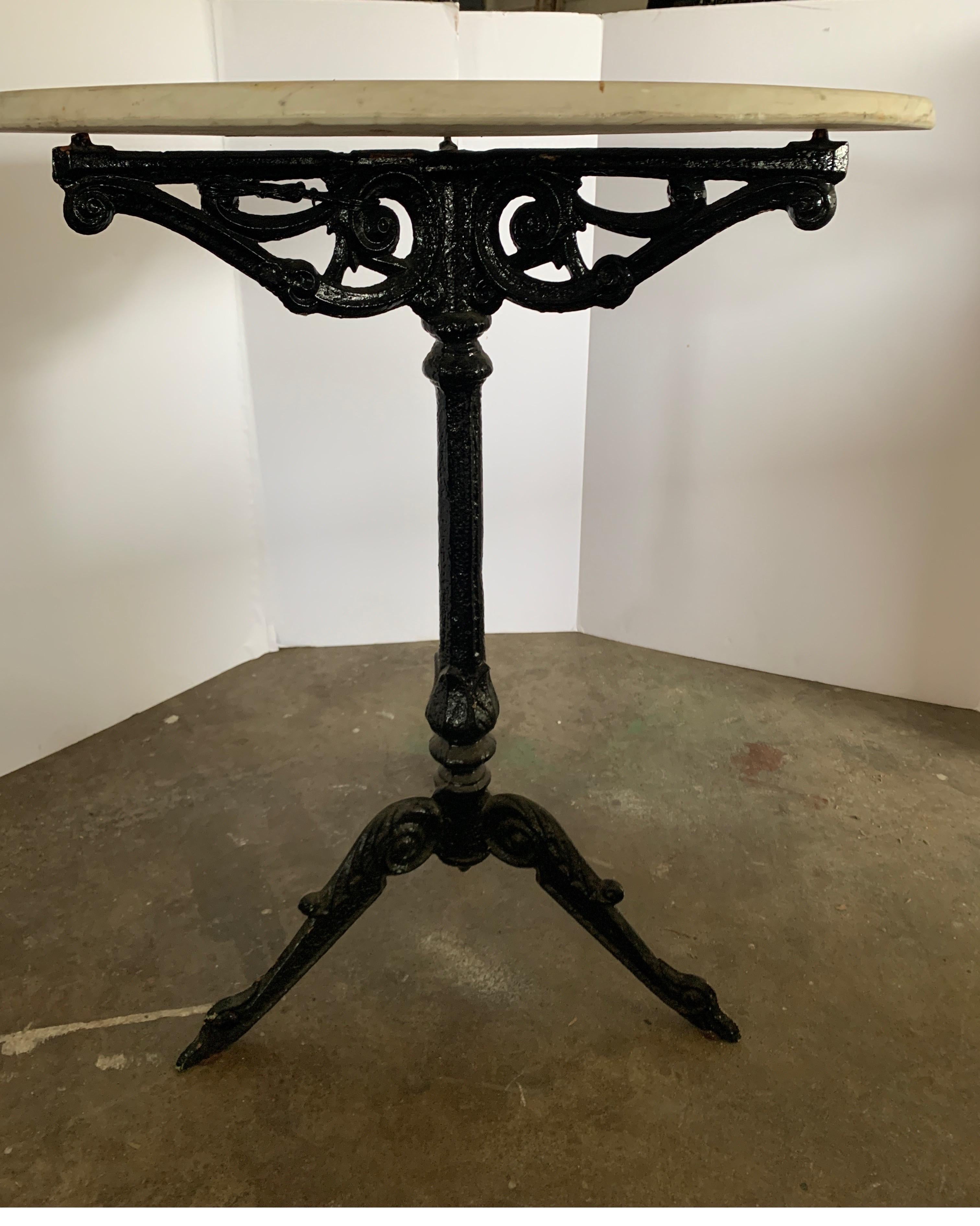 This is the typical bistro table used in restaurants throughout Europe. This one has the original white aged marble top and the base has been painted over to a shiny black. It is in great condition free of rust.