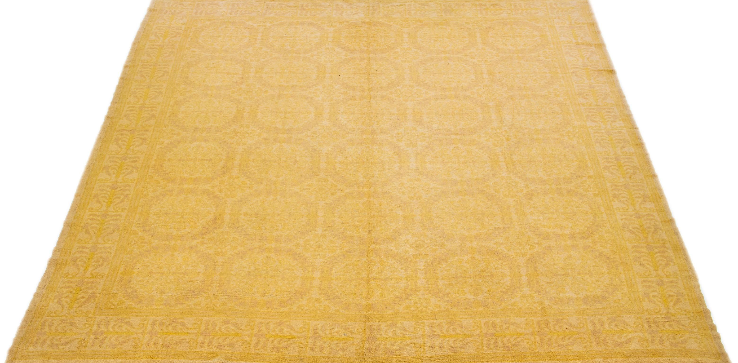 This hand-knotted wool rug boasts a beautiful vintage Spanish design featuring a goldenrod field color accentuated with stunning beige and tan accents in an elegant all-over pattern.

This rug measures 10'1