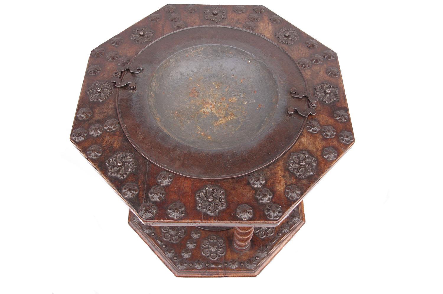 Walnut and metal brazier (or brasero) with two trays and two basins. The upper octagonal tray rests on the lower one thanks to four twisted columns. Trays receive in their center two metal basins surrounding by stylized carved flowers. 
The set