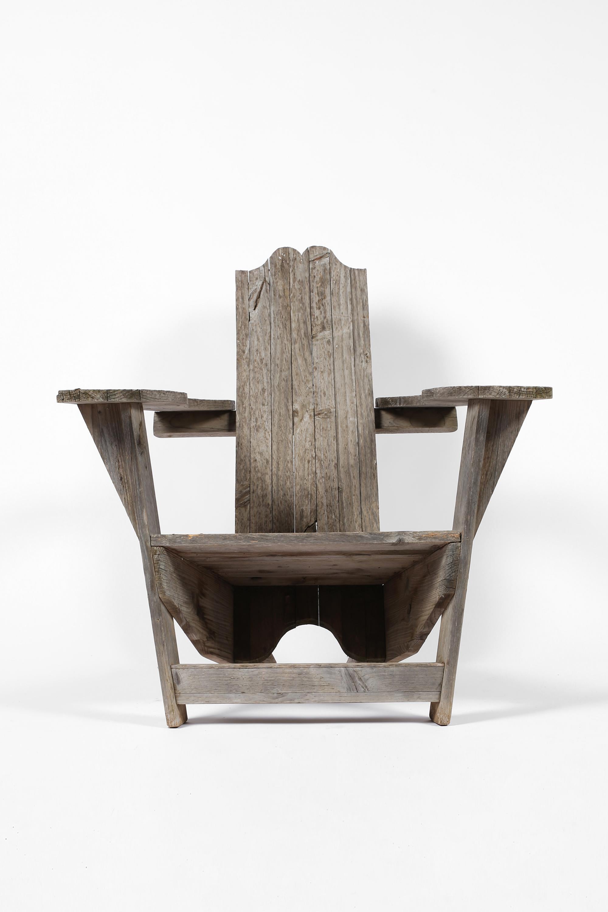 A large and sculptural ‘Adirondack’ or ‘Westport’ style armchair in heavily weathered pine timber. Originating from northern Spain, c. late 20th century.