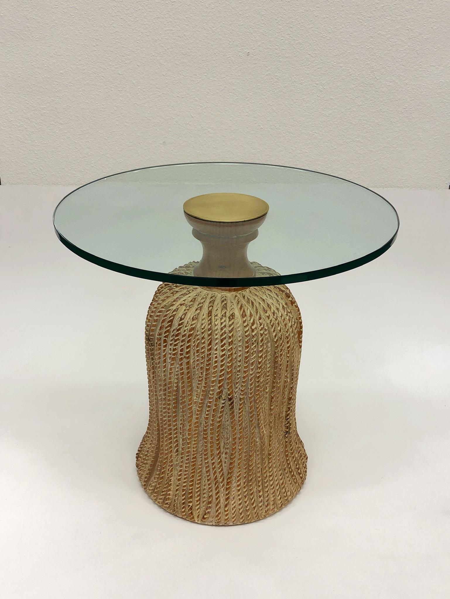 A glamorous 1970s Spanish carved wood tassel side table design by Sarreid Ltd.
the table base is solid pinewood with a new 1/2” thick glass top, a satin brass cap attaches the top to the base.
Dimensions: 20” diameter 19.75” high.