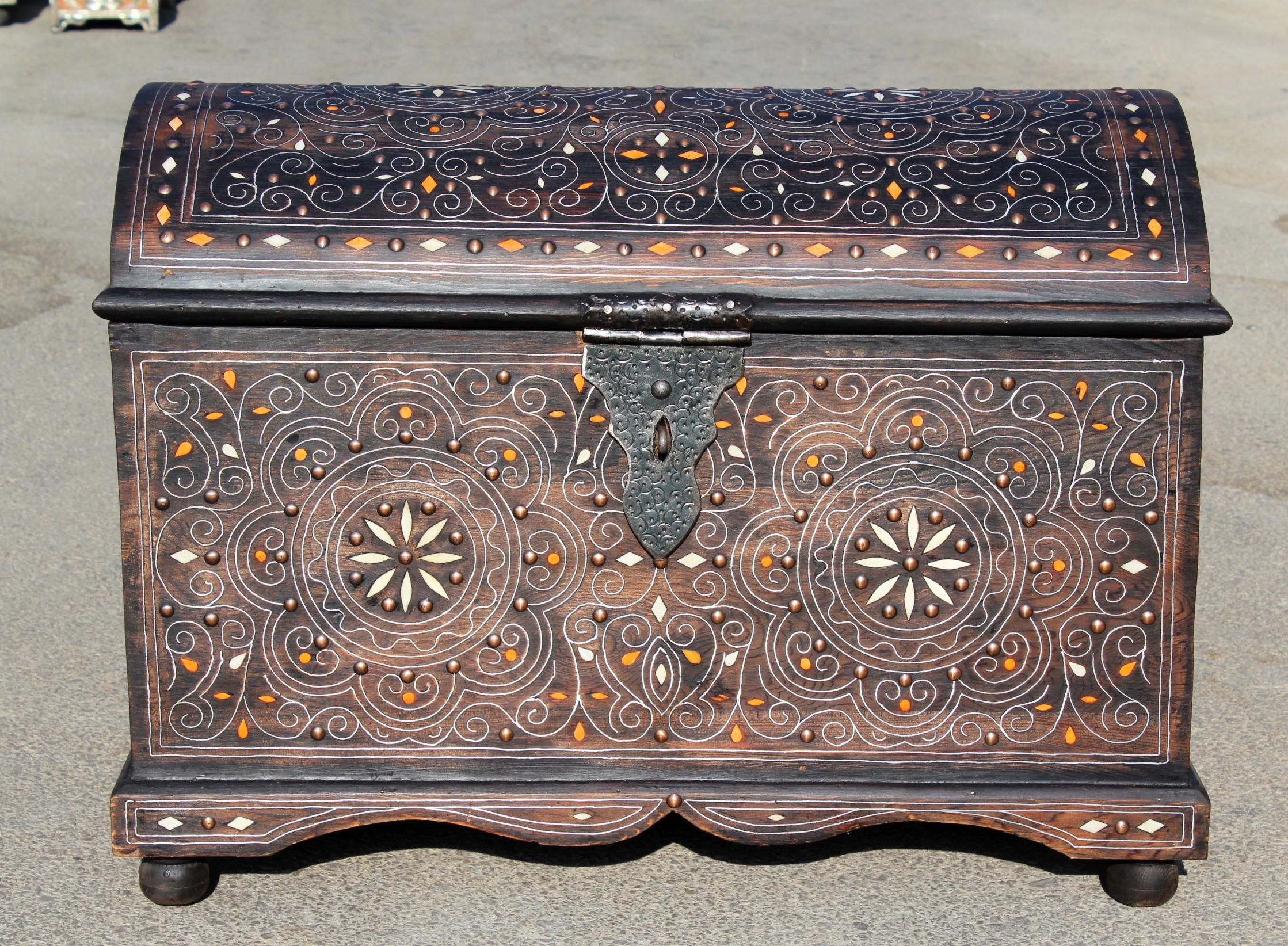 Spanish wooden chest with inlay decorations and iron fittings.