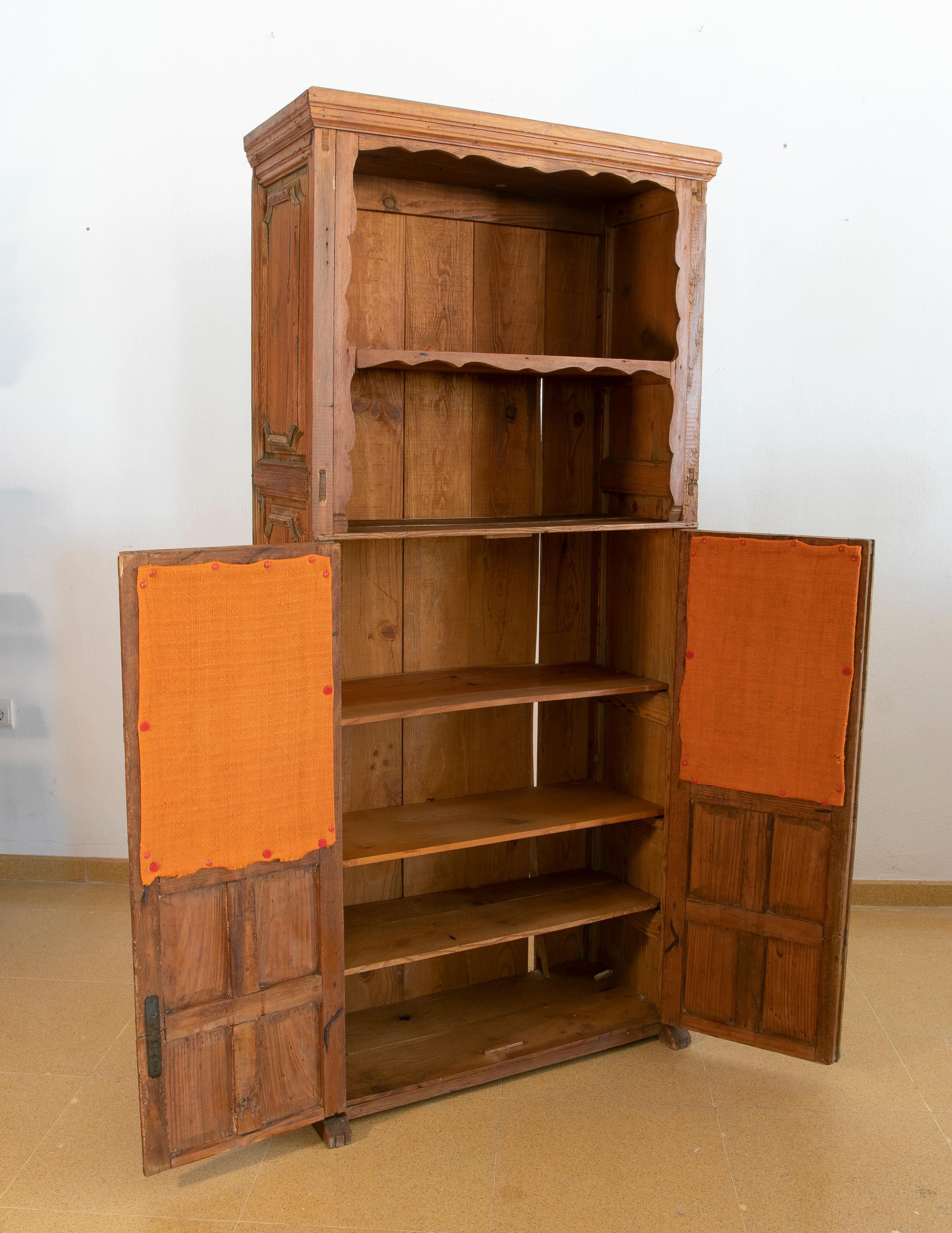Spanish wooden cupboard with shelves and lattice doors.