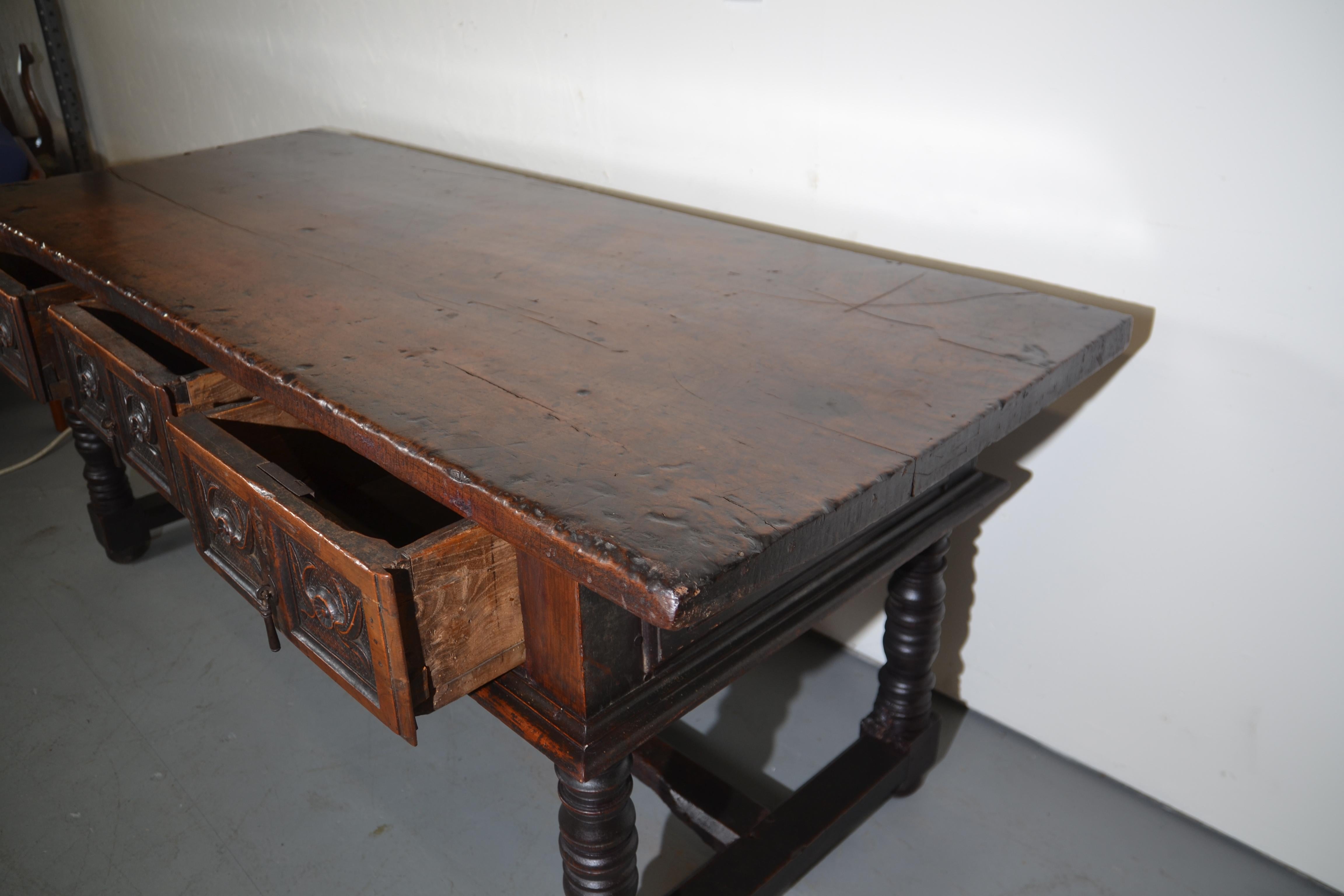 A superb 17th century Spanish multi-use Table. c.1680 Turned legs and a thick top with nice patina. There are 3 drawers to the front with carvings and old hardware. This table will not disappoint.