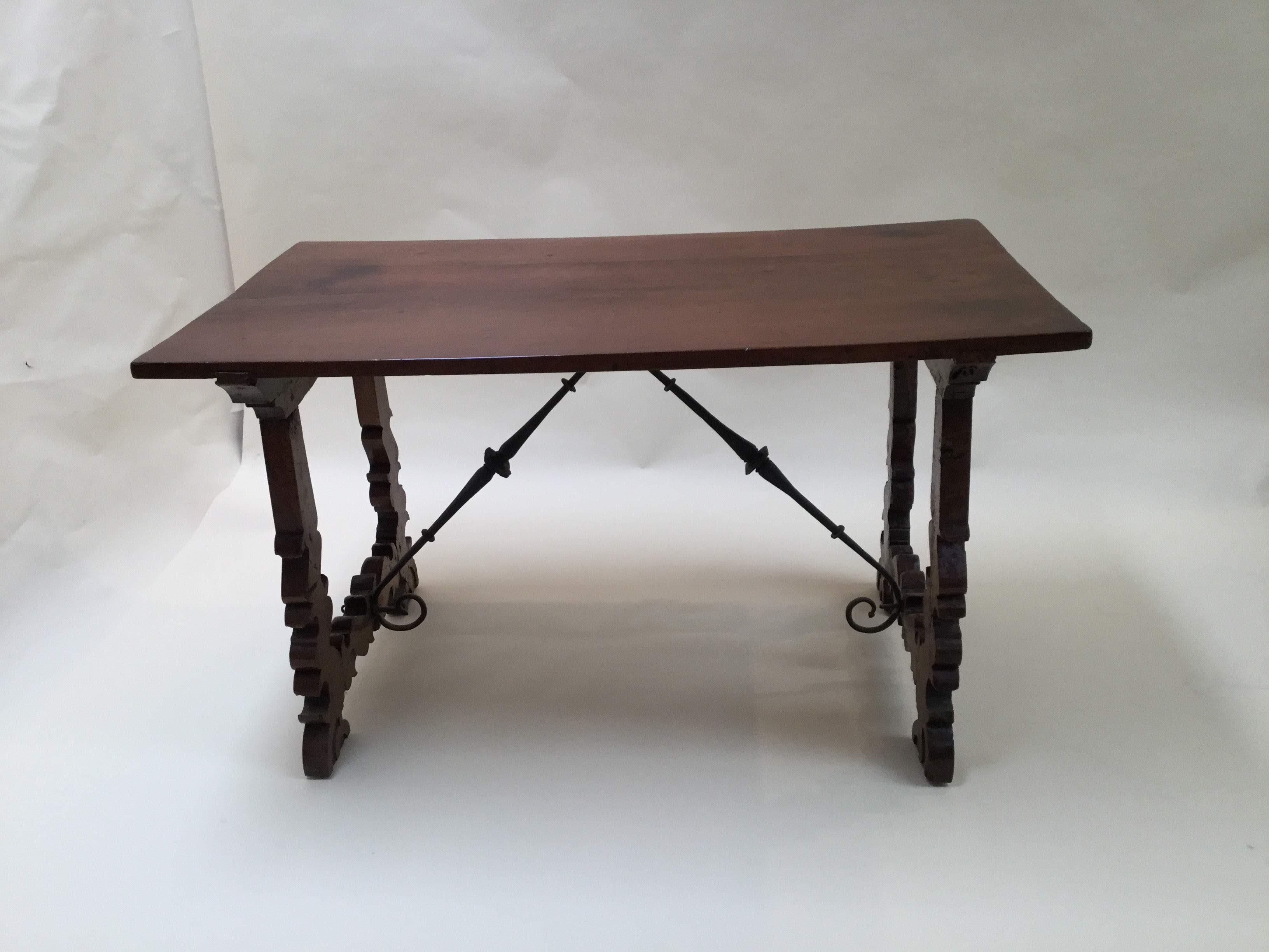 Spanish writing table with rectangular top on pierced double scroll-end-supports, joined by double iron stretchers on scrolled feet.
Beautiful restored top.
 