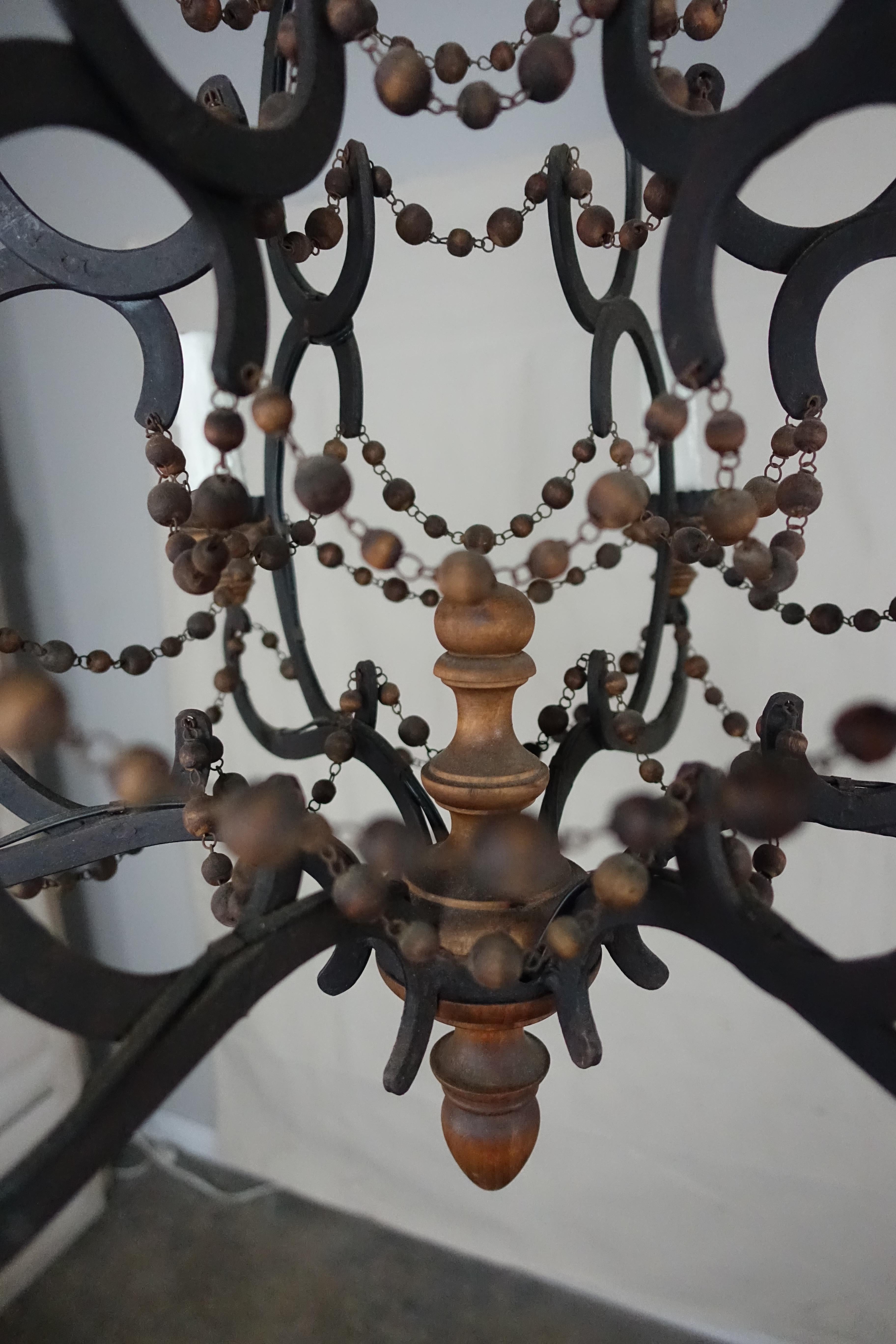 Spanish Wrought Iron and Wood Beaded Chandelier In Distressed Condition In Los Angeles, CA