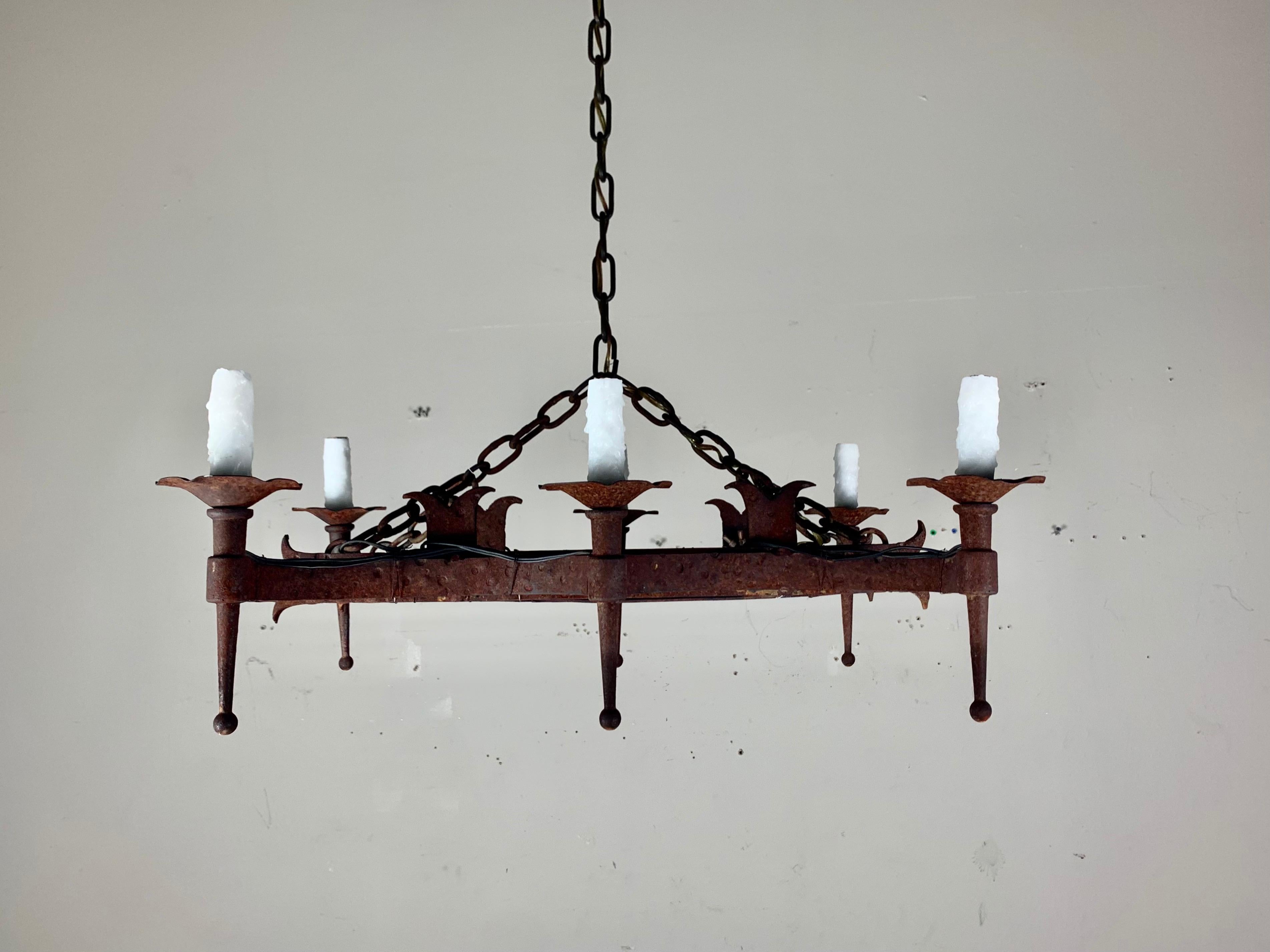 Spanish six light wrought iron chandelier. The fixture is newly rewired with drip wax candle covers. Chain & canopy included.