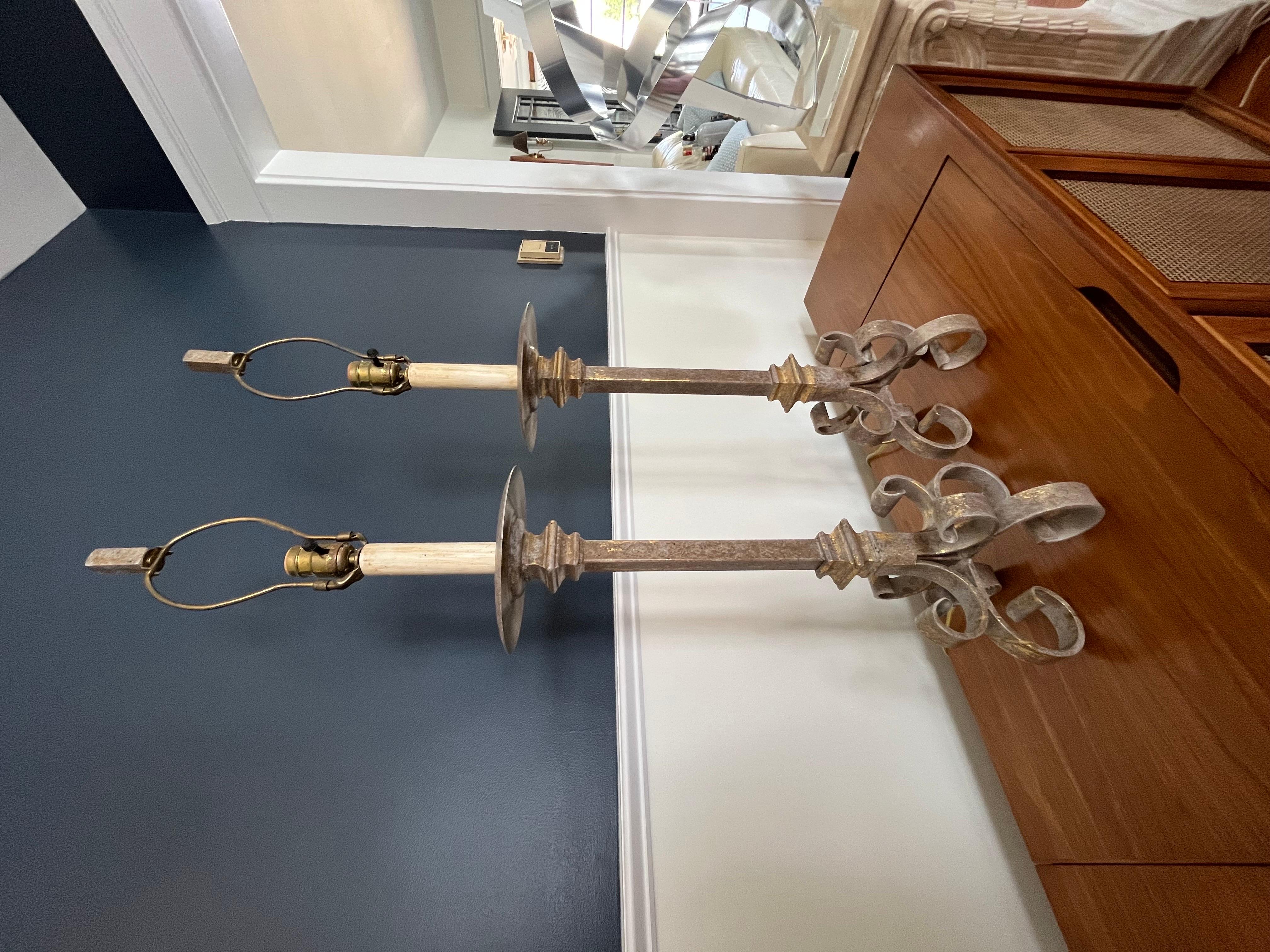 Classic styling in these wrought iron stick lamps. Gold fleck accents add to visual with a bit of drama. Matching iron finials. Substantial weigh and presence.