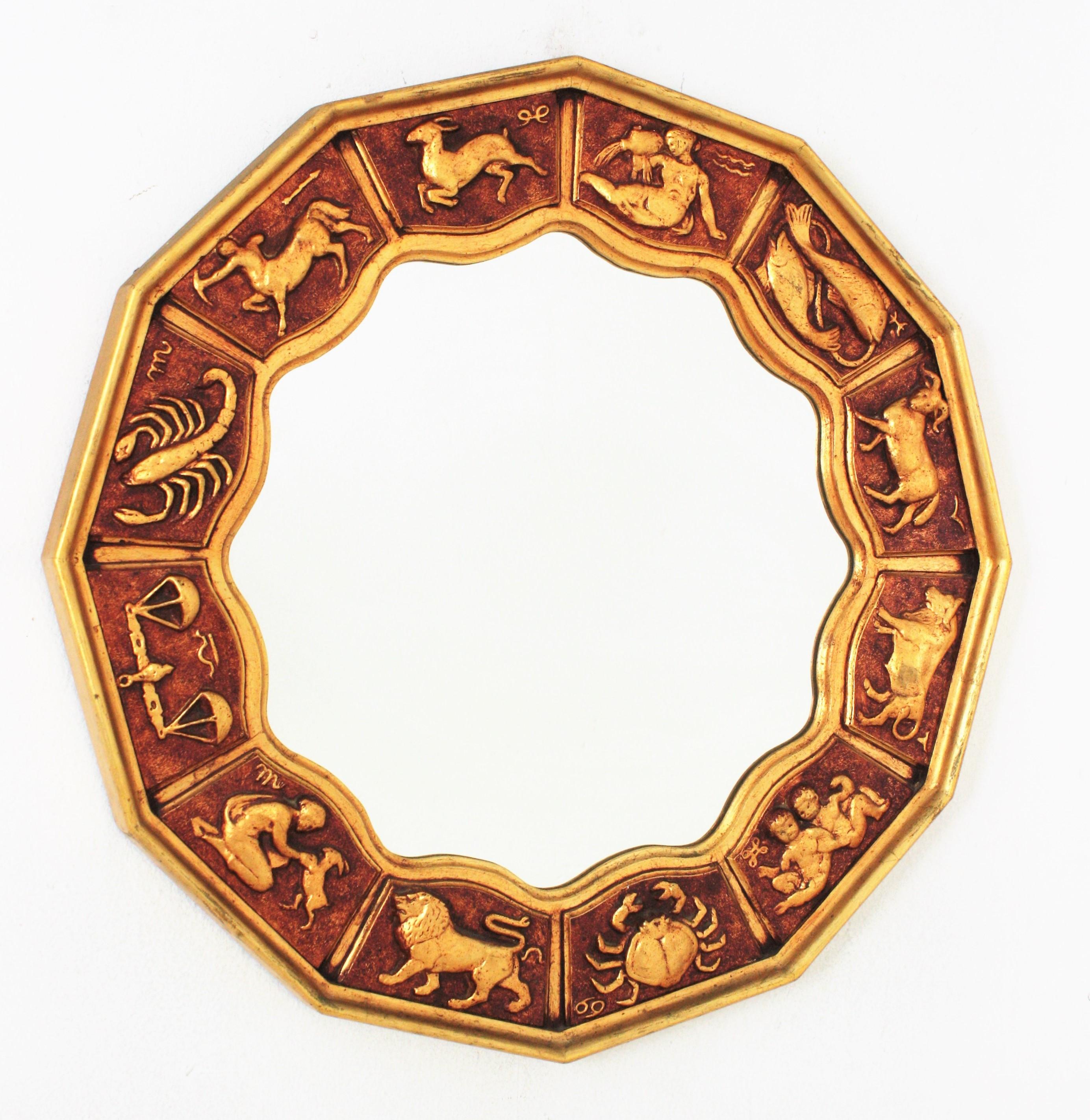Zodiac dodecagon wall mirror in gilt carved wood, Spain, 1950s-1960s.
Handcrafted Horoscope round 12 sided (dodecagon) mirror with 12 signs of zodiac in giltwood.
Stylized hand carved zodiac signs on a polihedral wooden frame and scalloped edge