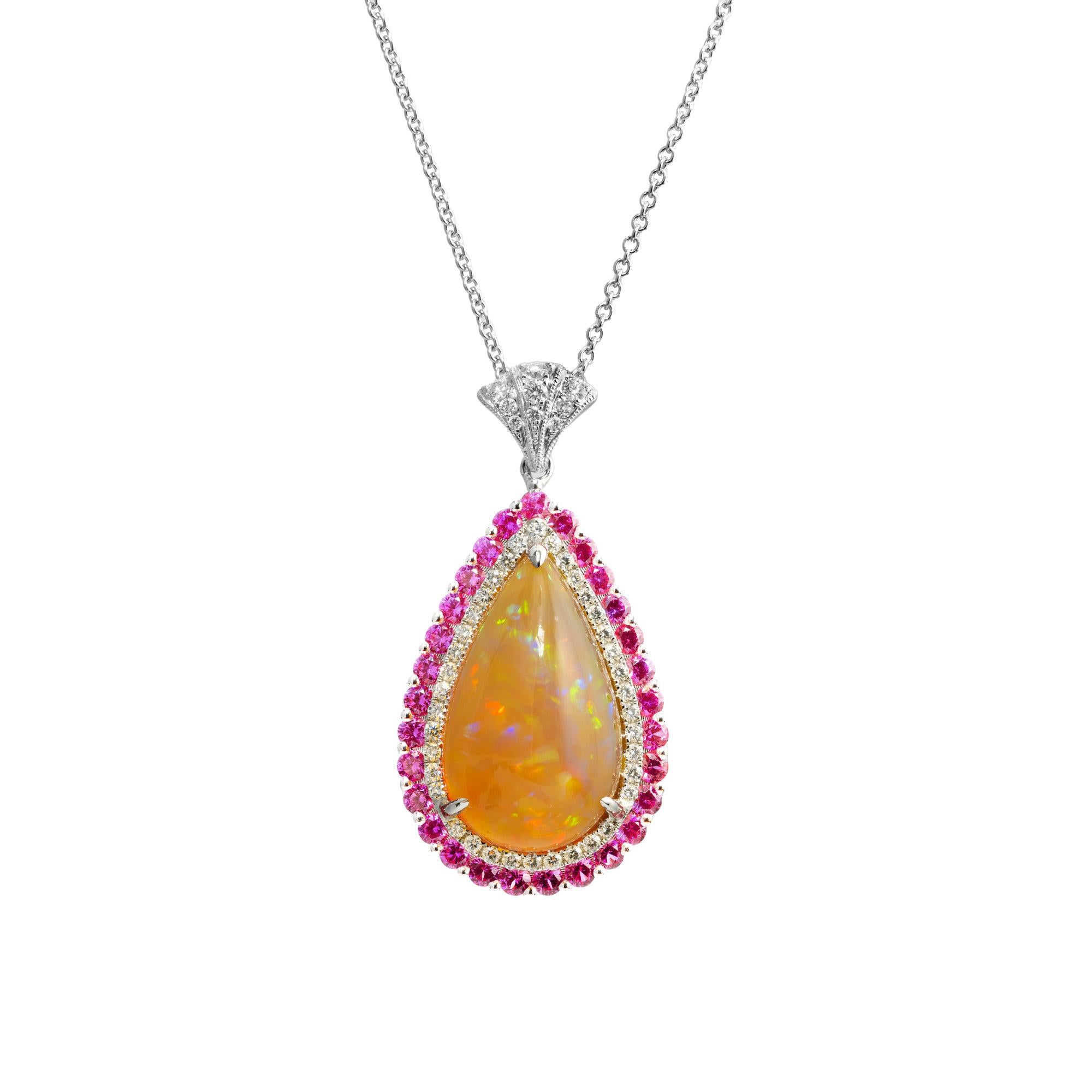 From designer Spark, this pendant necklace features a dazzling 8.23ct pear shaped cabochon opal that features a double halo of pink sapphires and round brilliant cut diamonds. The fanned shaped bail is adorned with by round brilliant cut diamonds.