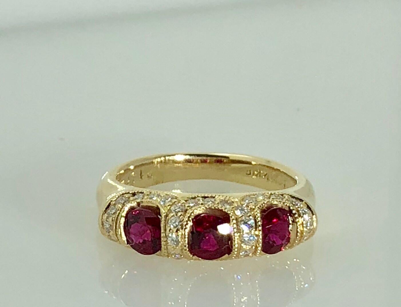 Spark Creations 18 Karat Yellow Gold Diamond and Ruby Contemporary Ring. This Spark creation is created in 18 karat yellow gold, weight- 5.5grams. This piece is adorned with 37 round cut diamonds = 0.36 carats total weight. This ring is a