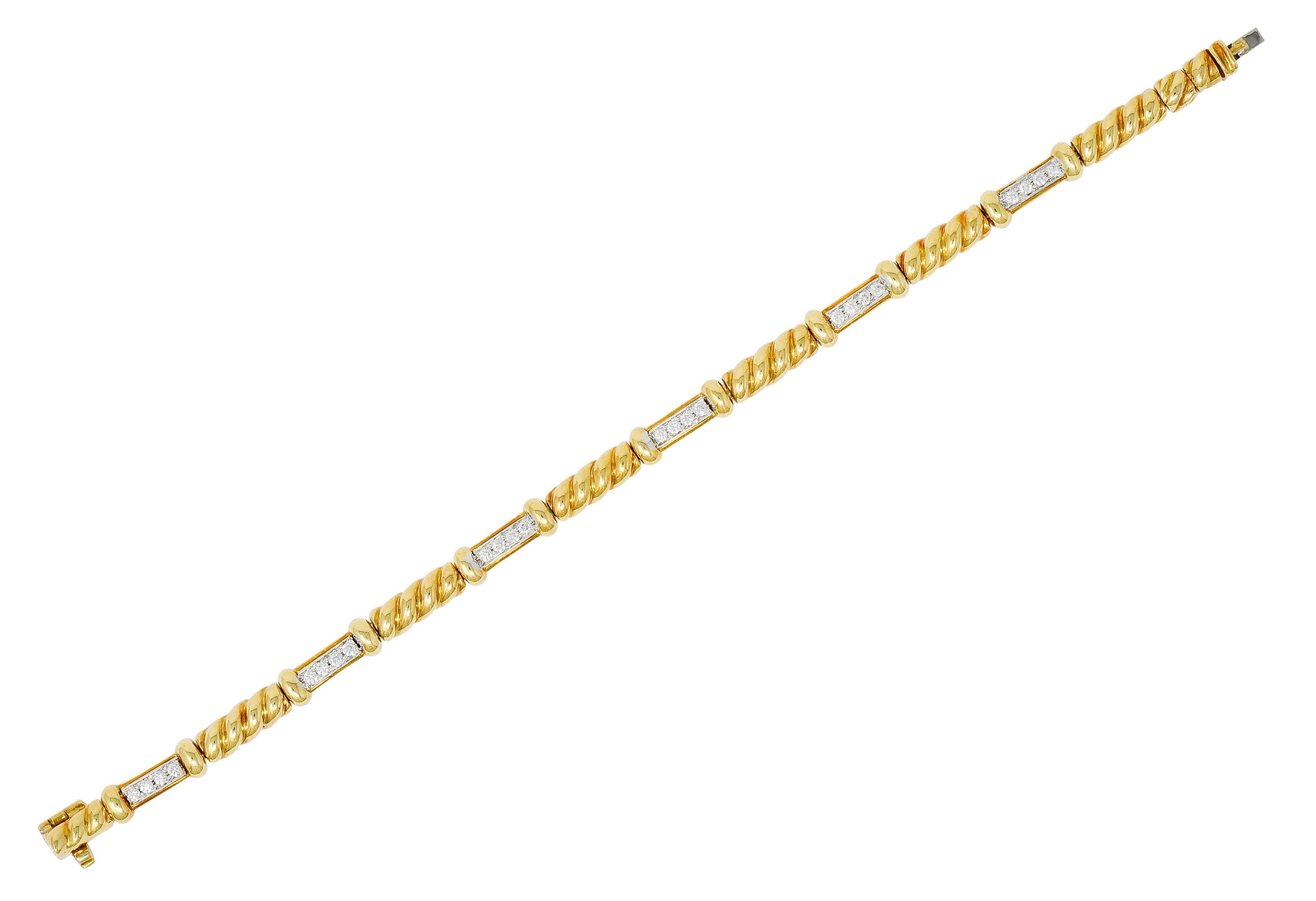 Bracelet is designed as deeply ribbed polished gold links alternating with diamond links

Round brilliant cut diamonds are bead set in white gold, as a row East to West

Weighing in total approximately 0.72 carat with G to I color and SI