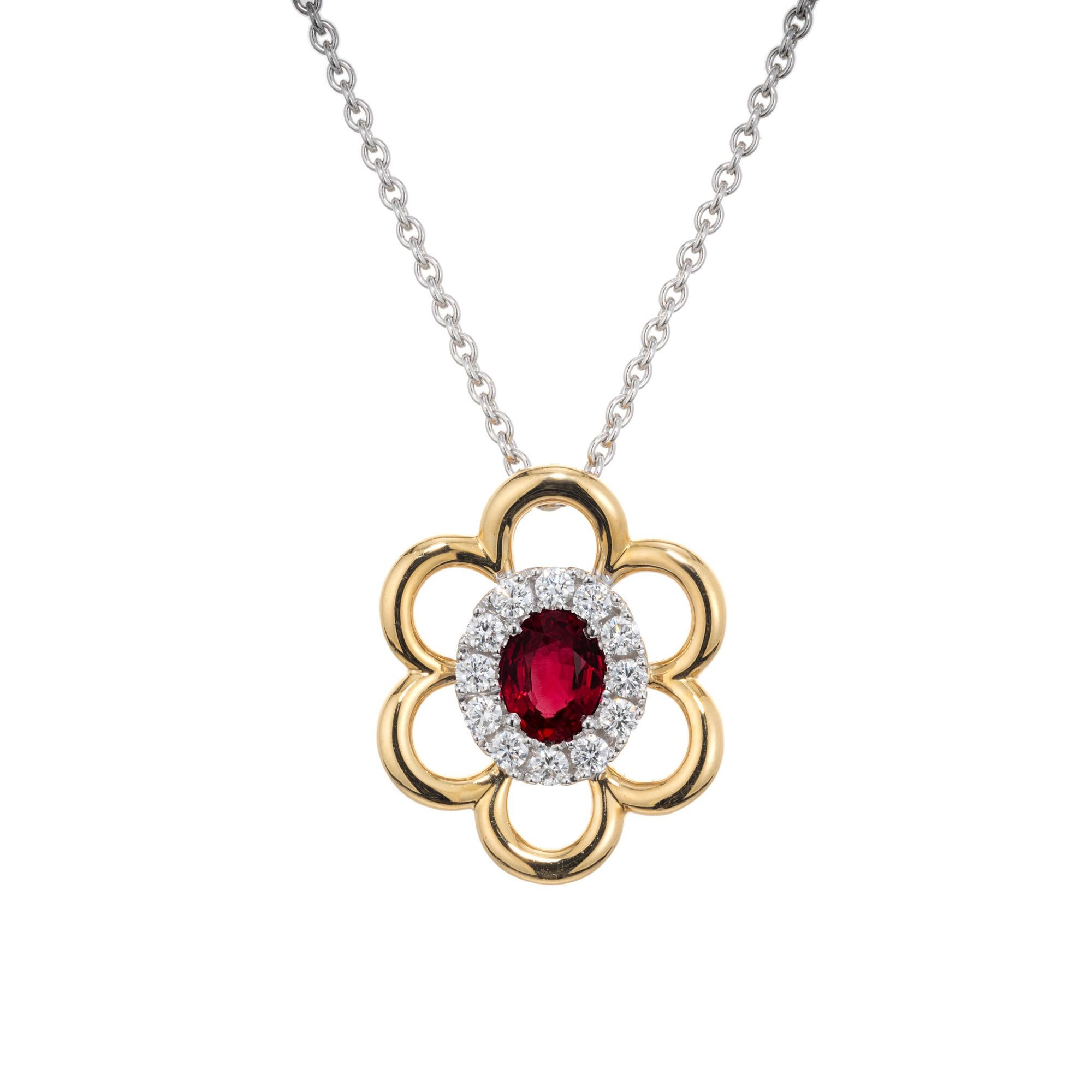 Ruby Diamond gold pendant necklace. GIA certified .50cts oval red ruby center stone with a halo of 12 round cut diamonds that are framed by a flower style 18k yellow gold halo. The 18k white gold chain is 18 inches in length. Designed and created by