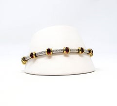 Bracelet station en or jaune/blanc 18 carats avec rubis et diamants scintillants
