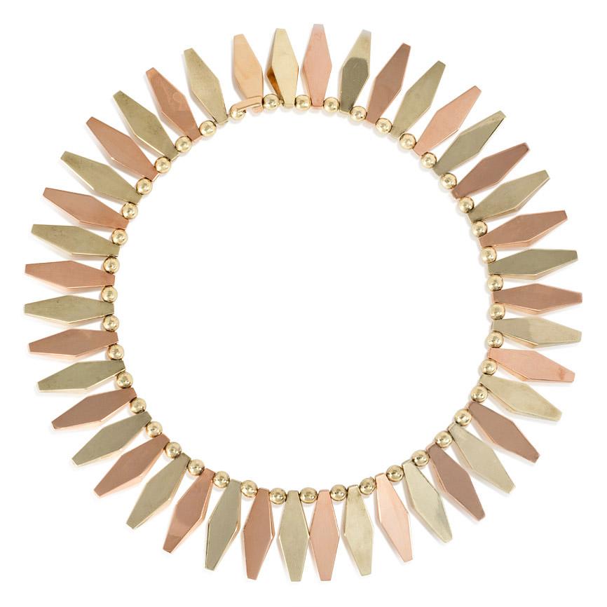A Retro 1940s collar necklace comprised of a fringe of alternating yellow and rose gold faceted kite-shaped links, in 14k.  Sparkes