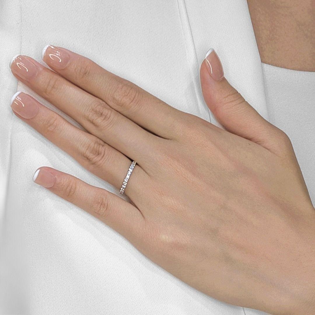 Adorn your hand with the captivating brilliance of this sparkling half eternity ring, exquisitely crafted in luxurious 18K white gold. Sixteen natural round brilliant diamonds, totaling a dazzling 0.37ct, are meticulously set to create a continuous