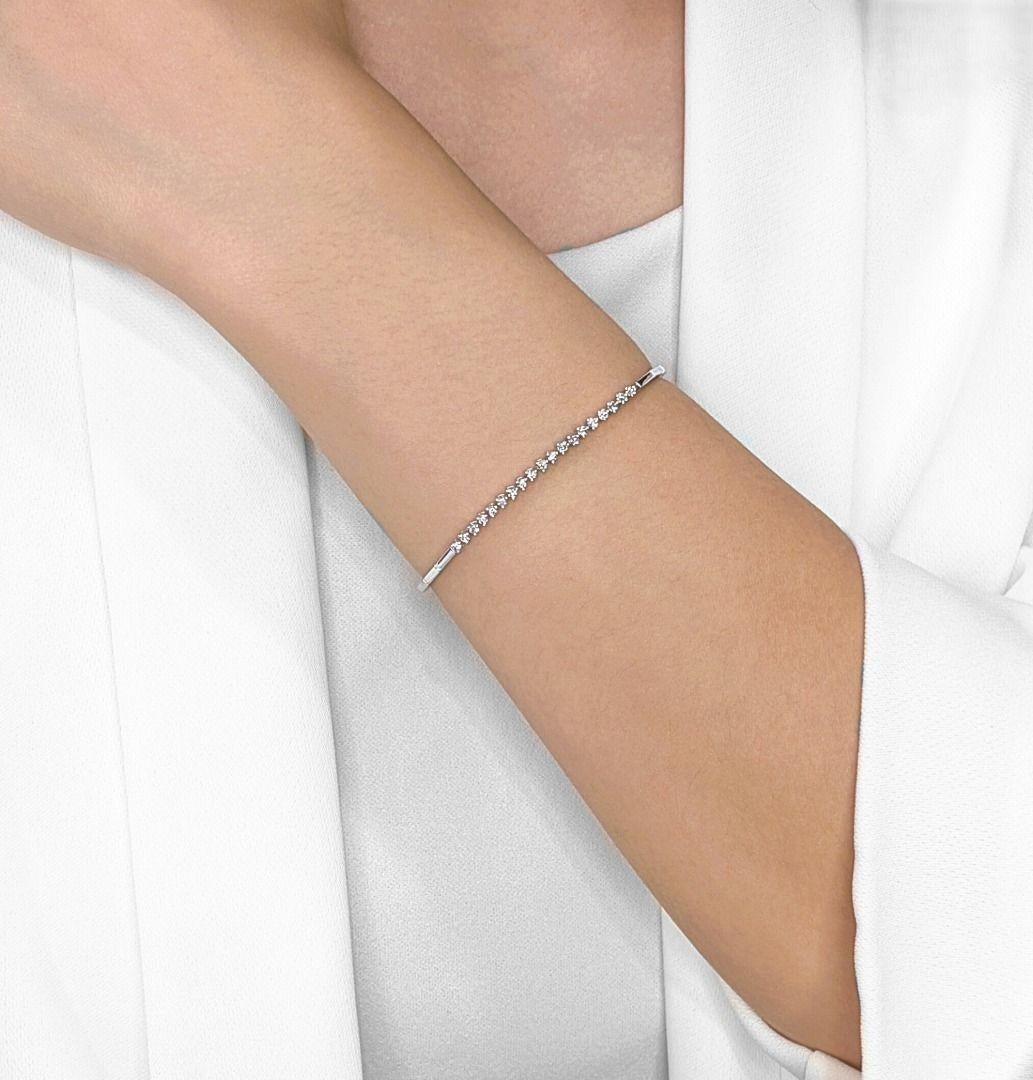 Adorn your wrist with the captivating sparkle of this exquisite 18K white gold bracelet, a timeless piece designed to elevate any ensemble. Nineteen dazzling natural round brilliant diamonds, totaling a brilliant 0.38ct, are meticulously set to