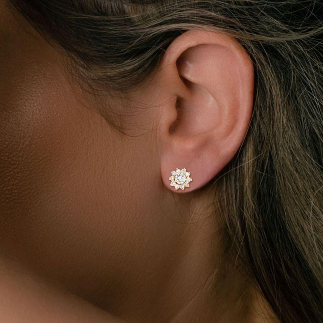 This exquisite pair of drop earrings features two round brilliant natural diamonds as the main stones, each with a carat weight of 0.38ct, showcasing a stunning G color grade, VS1 clarity grade, and a Very Good cut grade. The diamonds are elegantly