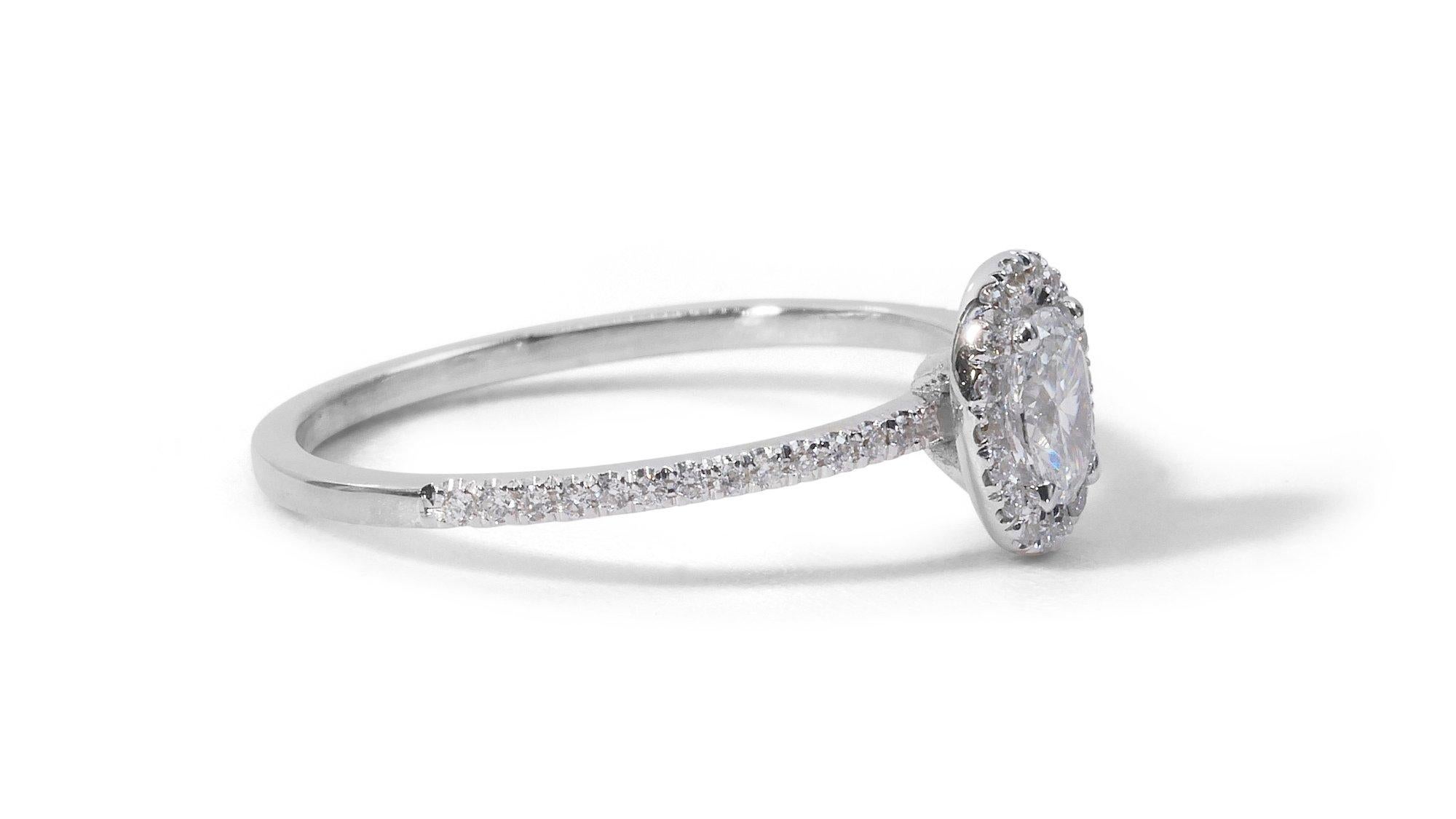 Sparkling 0.85ct Diamond Halo Ring in 18k White Gold - GIA Certified

Introducing this stunning 18k white gold diamond halo ring. The centerpiece is a dazzling oval-cut diamond with a carat weight of 0.71-carat. Surrounding the main stone are 40