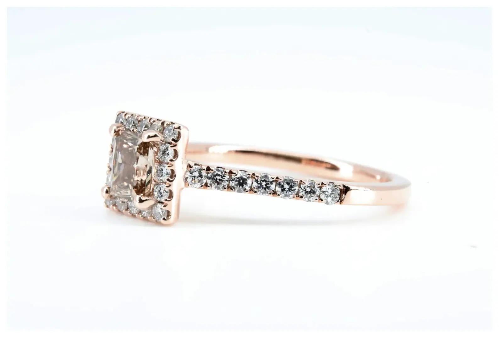 A champagne and colorless diamond engagement ring in 14 karat rose gold.

Centered by a 0.75 carat fancy rectangular radiant cut champagne diamond of VS2 clarity.

Accented further by 0.20 carats of G color, VS2 clarity pave set round cut