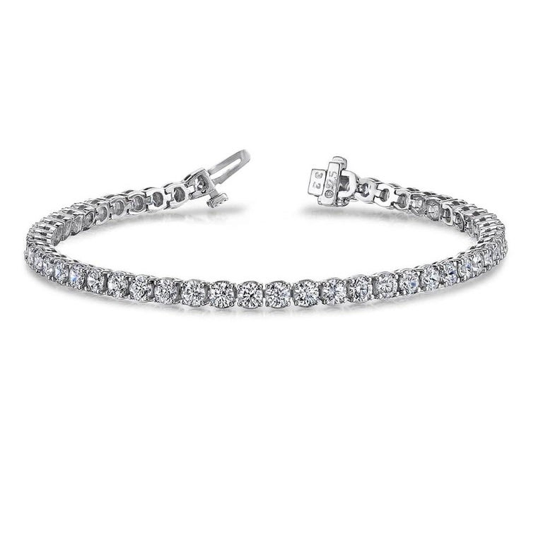 This bracelet shines with a sparkling classic elegance. It features round white diamonds in a four prong setting, totaling 10.26 carats. Set in 14k White Gold. 44 Diamonds H-I color, SI quality.
Suggested retail price $52,078

Diamond Town is