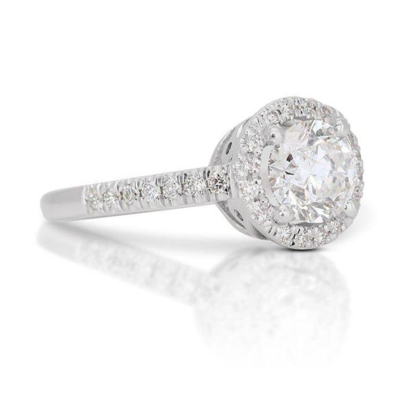 Embrace timeless elegance and unparalleled sparkle with this exquisite ring, showcasing a mesmerizing 1.16-carat round brilliant diamond. This captivating centerpiece, boasting the coveted G color (colorless) and Si2 clarity  radiates brilliance and