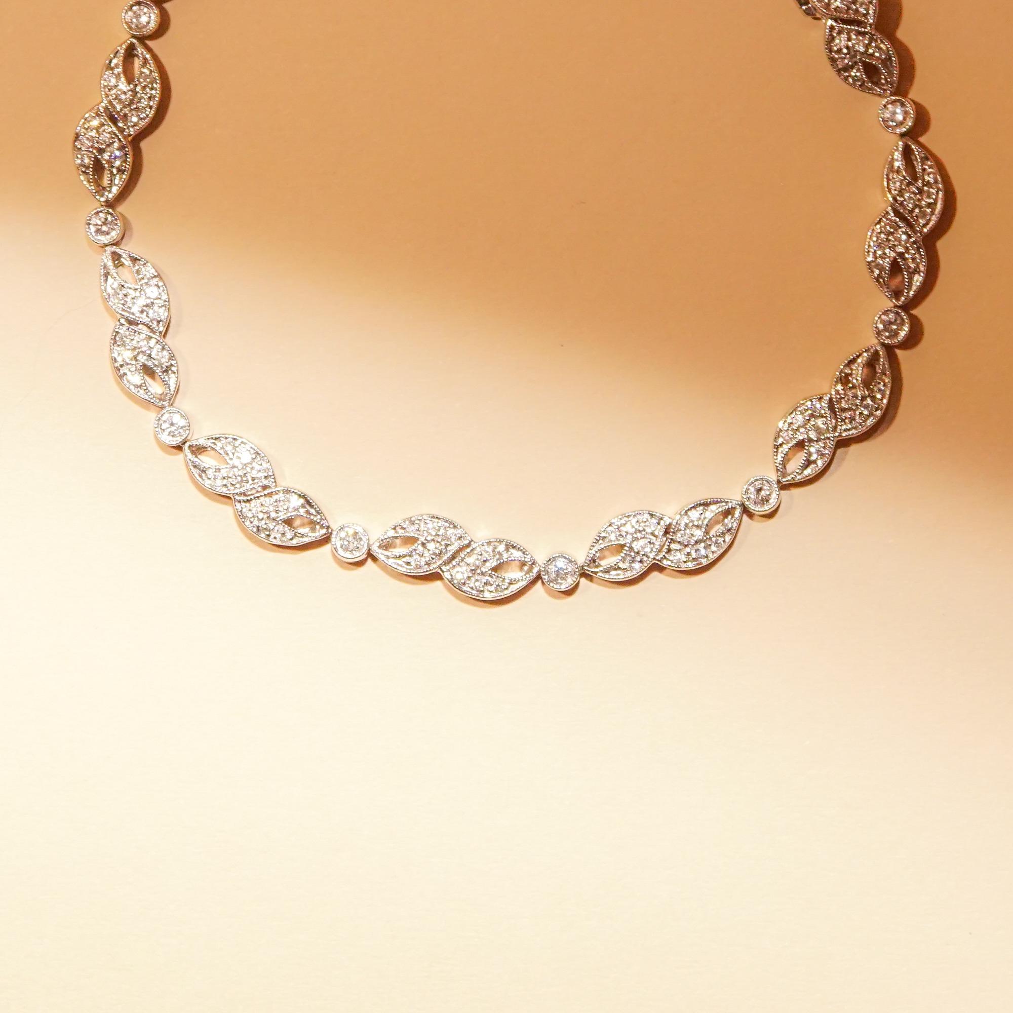 A sparkling 14k white gold diamond link bracelet boasting over 100 dazzling diamonds. Features an articulated single strand of alternating links, 11 larger fancy links and 11 smaller round bezel links each set with its own .03T brilliant diamond