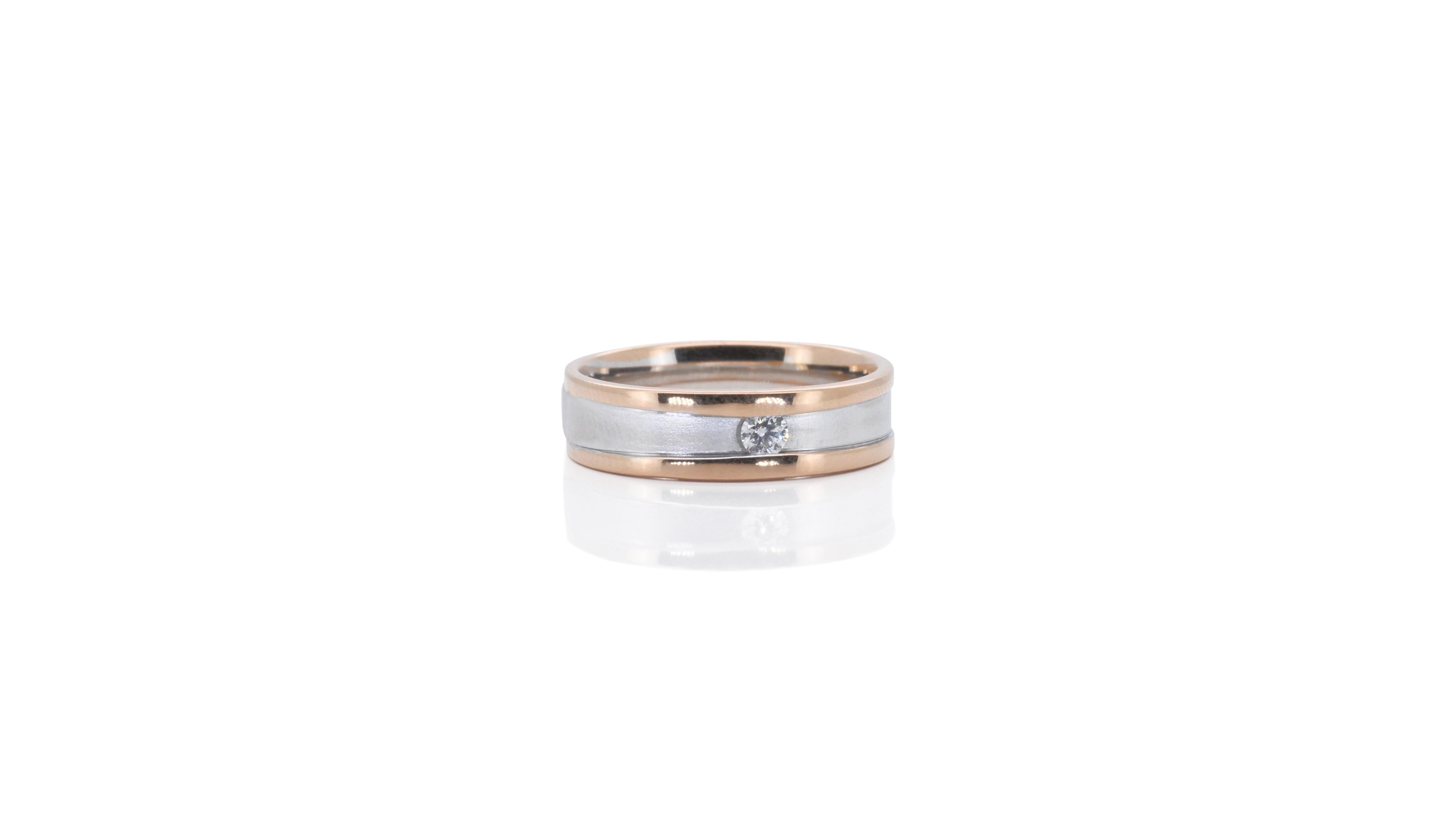 A classic solitaire wedding band ring with a dazzling 0.05 carat round brilliant diamond. The jewelry is made of 18k white gold and rose gold with a high quality polish. It comes with a fancy jewelry box.

Product Details:

Metal: 18K White & Rose