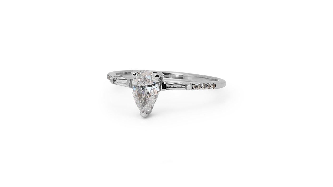 A gorgeous 3 stone ring with a dazzling 0.52-carat pear brilliant natural diamond. It has 0.23 carat of side diamonds which add more to its elegance. The jewelry is made of 18K White Gold with a high quality polish. It comes with GIA certificate and