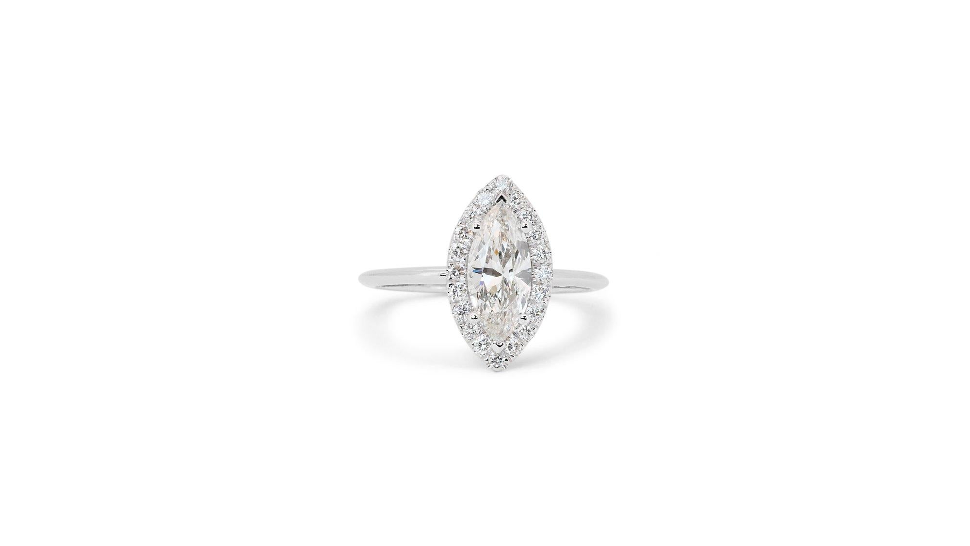 A stunning halo ring with a dazzling 0.86 carat marquise natural diamond. It has 0.23 carat of side diamonds which add more to its elegance. The jewelry is made of 18K White Gold with a high quality polish. It comes with AIG certificate and a fancy