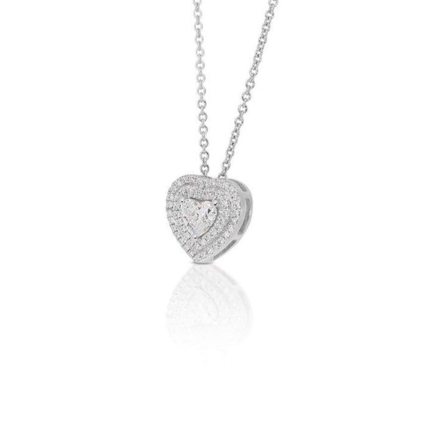 This pendant isn't just an ornament; it's a beacon of your inner radiance, captured in the sparkling embrace of diamonds. Nestled in a cradle of polished 18K white gold, a magnificent 0.5-carat heart-shaped diamond takes center stage, its