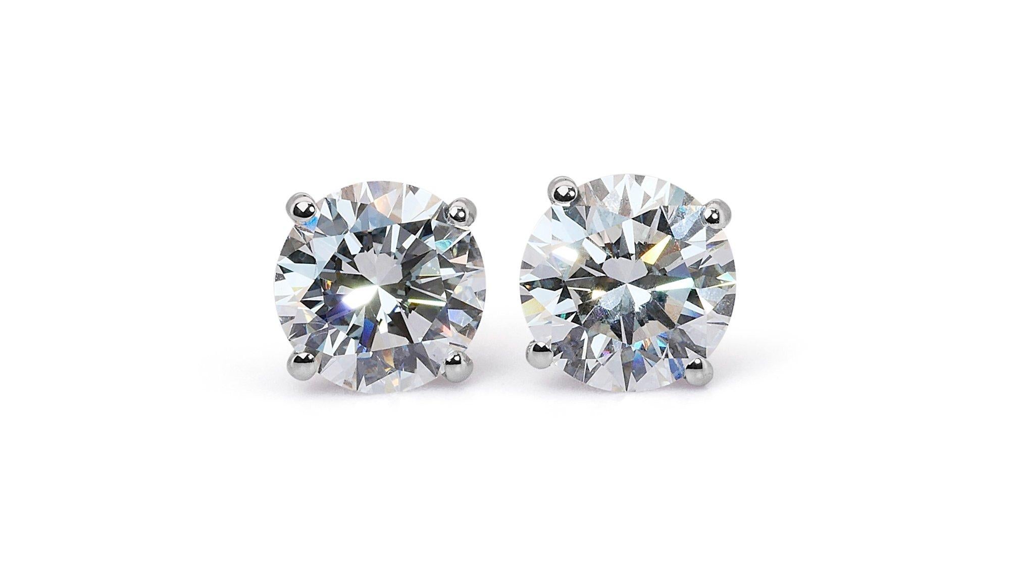 A sophisticated classic pair of stud earrings with a dazzling 3.13 carat total weight round brilliant natural diamonds with Ideal cut by Gia lab, means that this pair of diamonds is extremely shine and sparkles.

The ring is made of 18K White Gold
