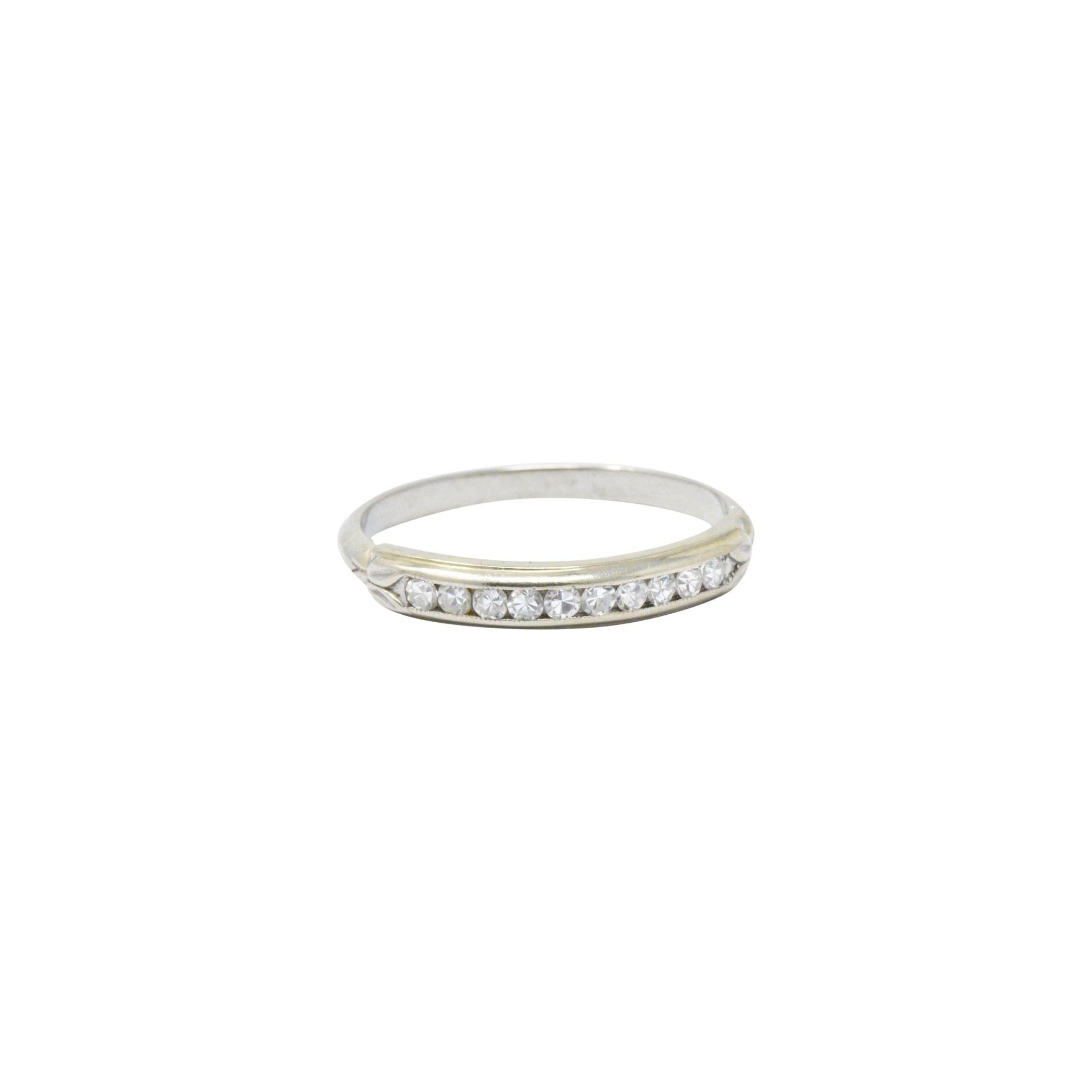 Channel set to the front with ten single cut diamonds, approximately 0.20 carats total, F/G color, VS to SI clarity 

Delicate foliate motif detail to the gold flanking the diamonds

Can be worn as a wedding band or as a great stacking ring

Ring