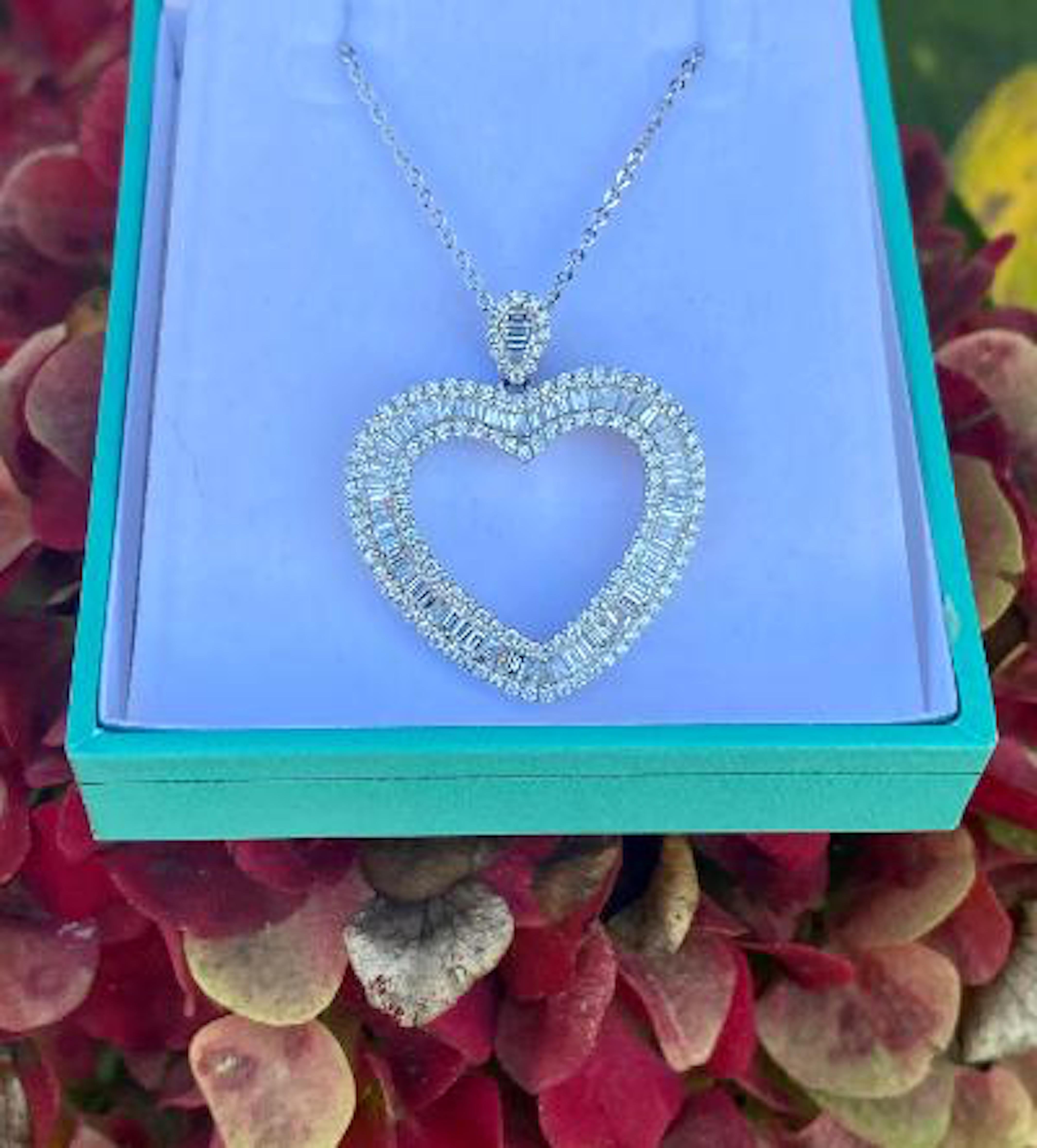 Beautiful and very sparkly, hand made 14 karat white gold open heart diamond pendant necklace with matching diamond bale features 116 round brilliant diamonds and 65 baguette diamonds having the total approximate combined weight of 3.50 carats.