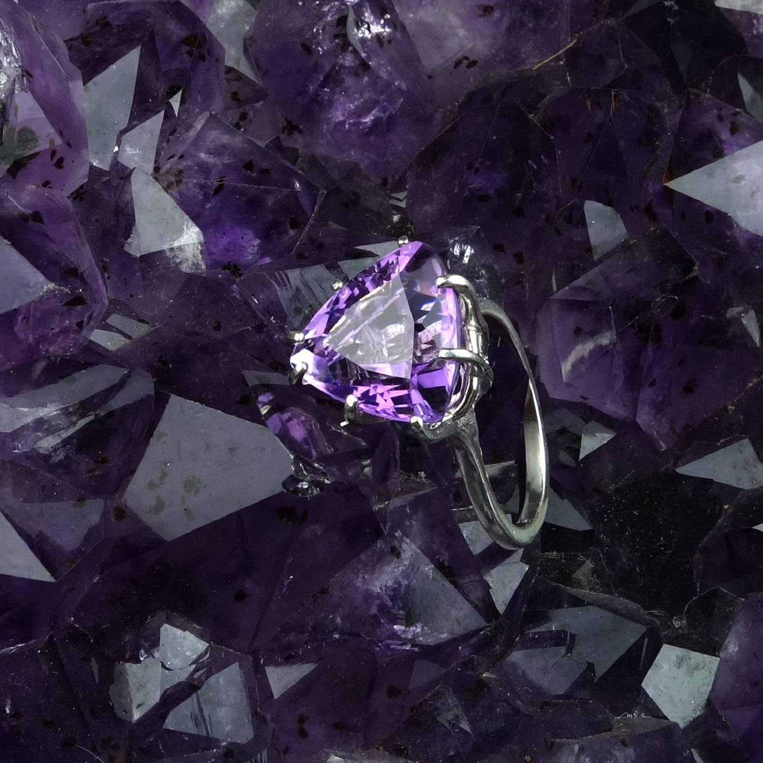 This Trillion Amethyst just dances with the light!  It is 8.5 carats of joy.  Set in a basket of Sterling Silver the Amethyst is a perfect ring for all occasions.  Sizable 8