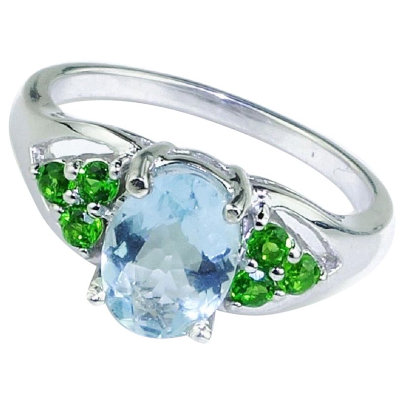 Custom made, lovely ring featuring glittering, oval blue Aquamarine flanked by six sparkling green Chrome Diopside, three on each side. This unique March birthstone ring is a winner in blue and green! Aquamarine is in the Beryl family. Also, in the