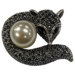 Sparkling Crystal Silver Fox enveloping a Faux Pearl Brooch Pin